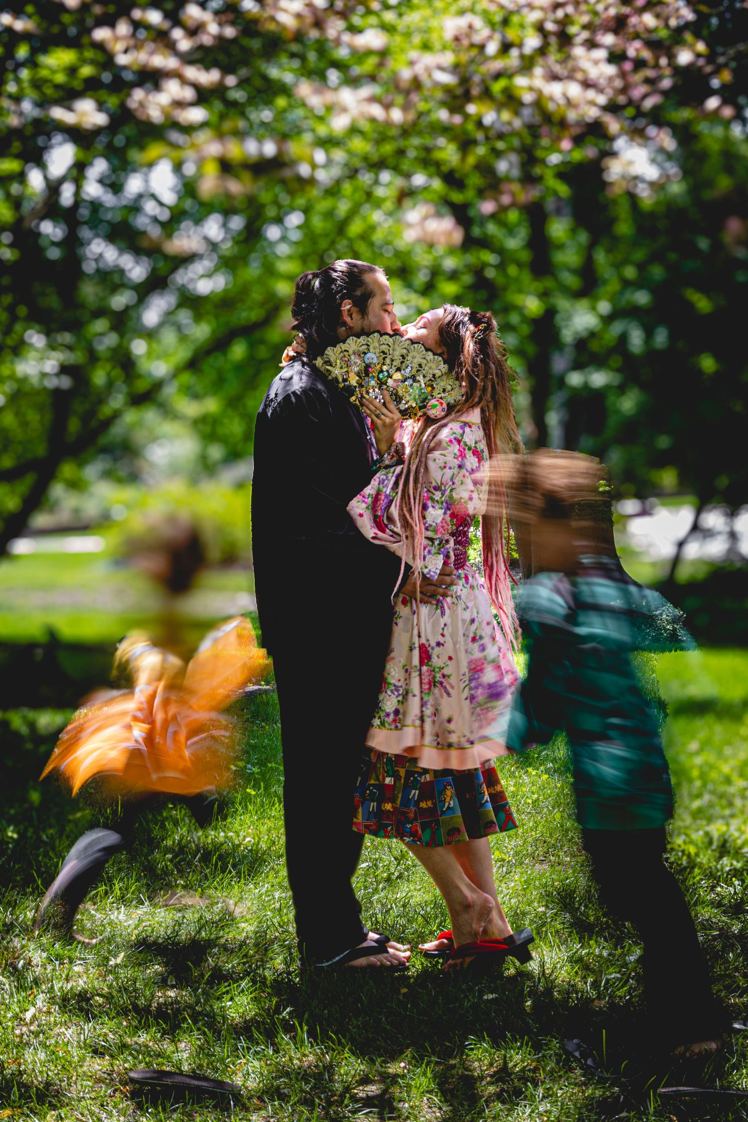 Children playing and running in a sunlit garden with motion blur effects. Botanical Gardens. Family Portrait