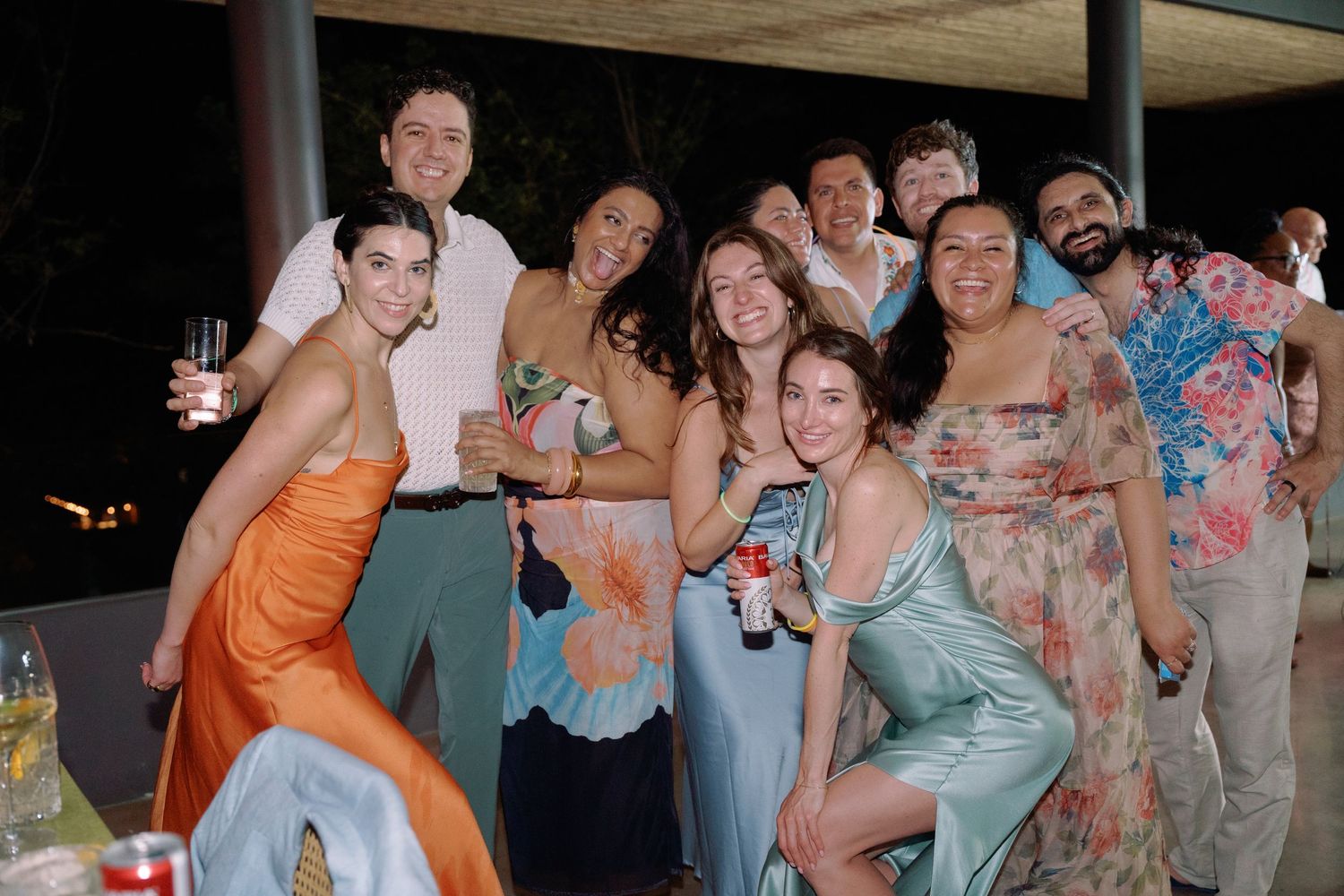 Wedding party and guests dancing and celebrating at an outdoor reception.