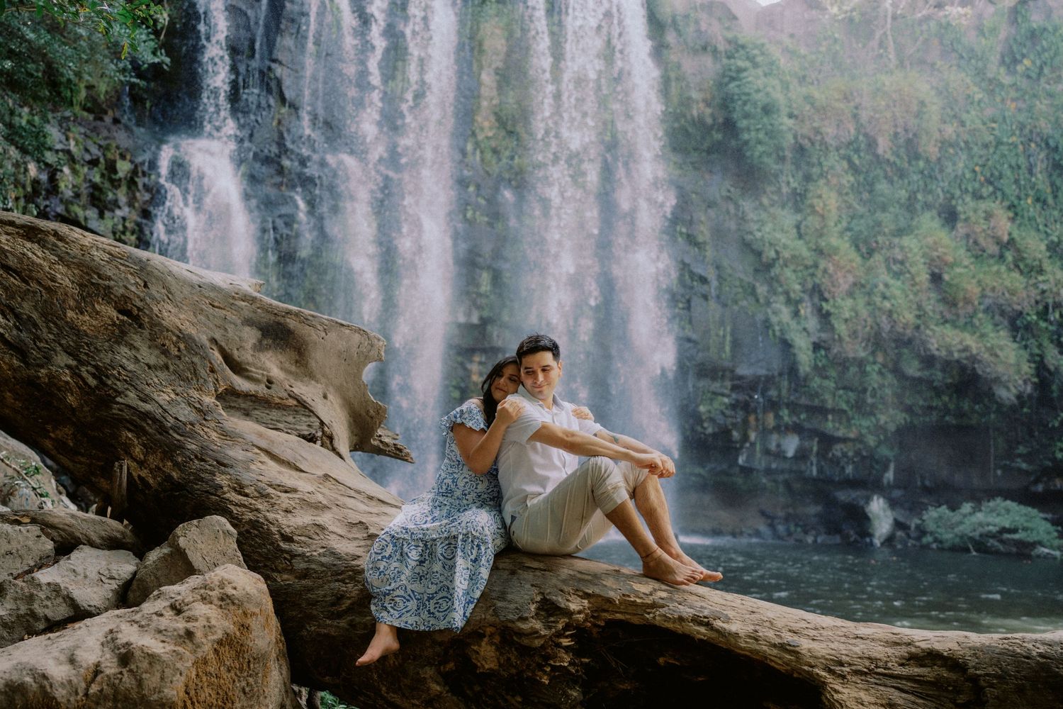 A scenic waterfall photoshoot location with natural rock formations and flowing water.