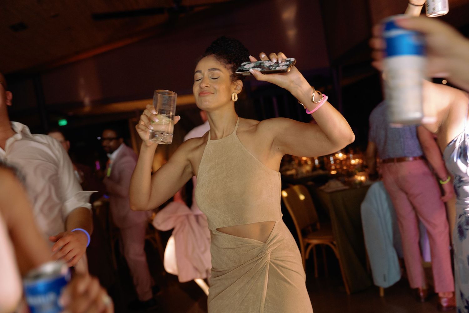 Guests enjoying themselves on a dimly lit dance floor at a wedding celebration.