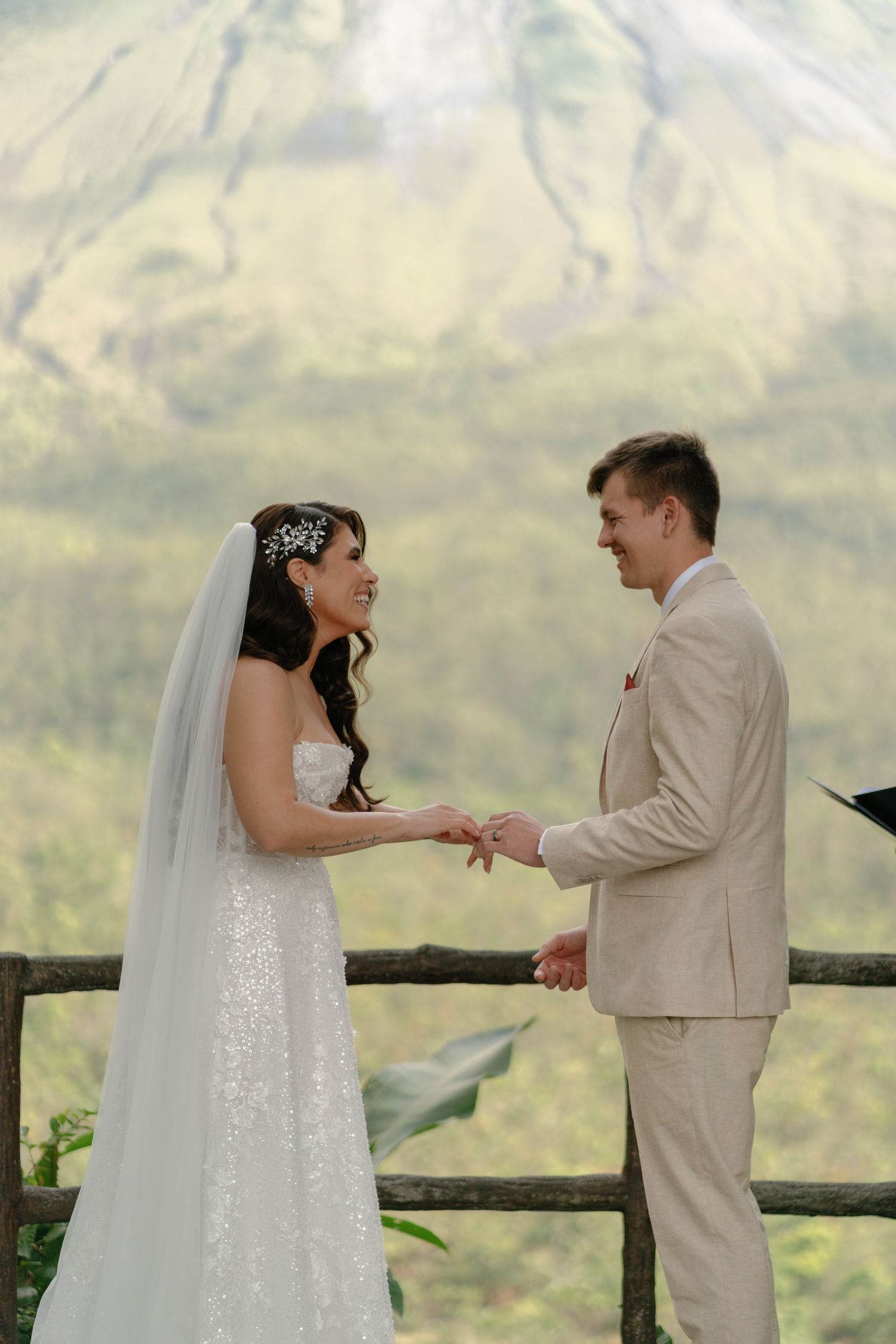 A wedding ceremony takes place with a stunning mountain backdrop.
