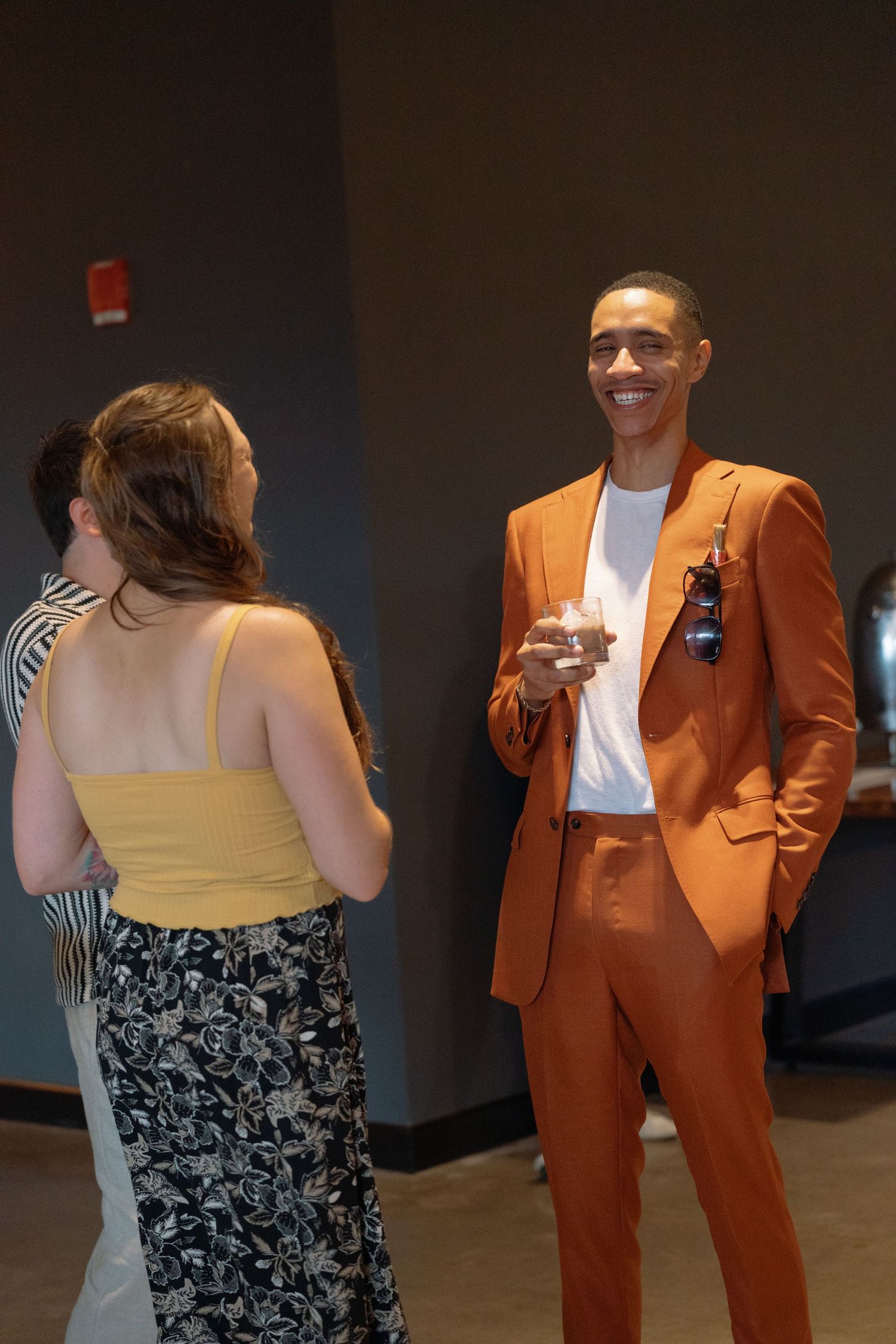Wedding guests in formal attire dance and celebrate at a reception.