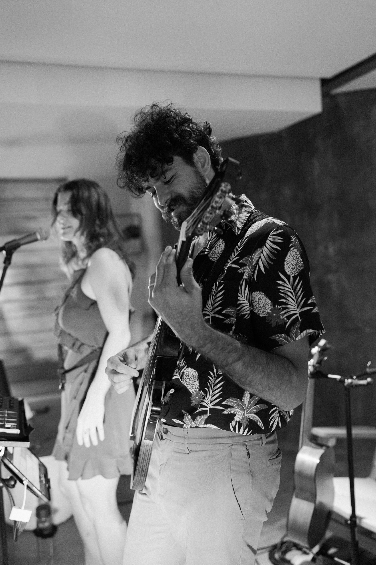 Black and white photo sequence showing a band performing energetically on stage.