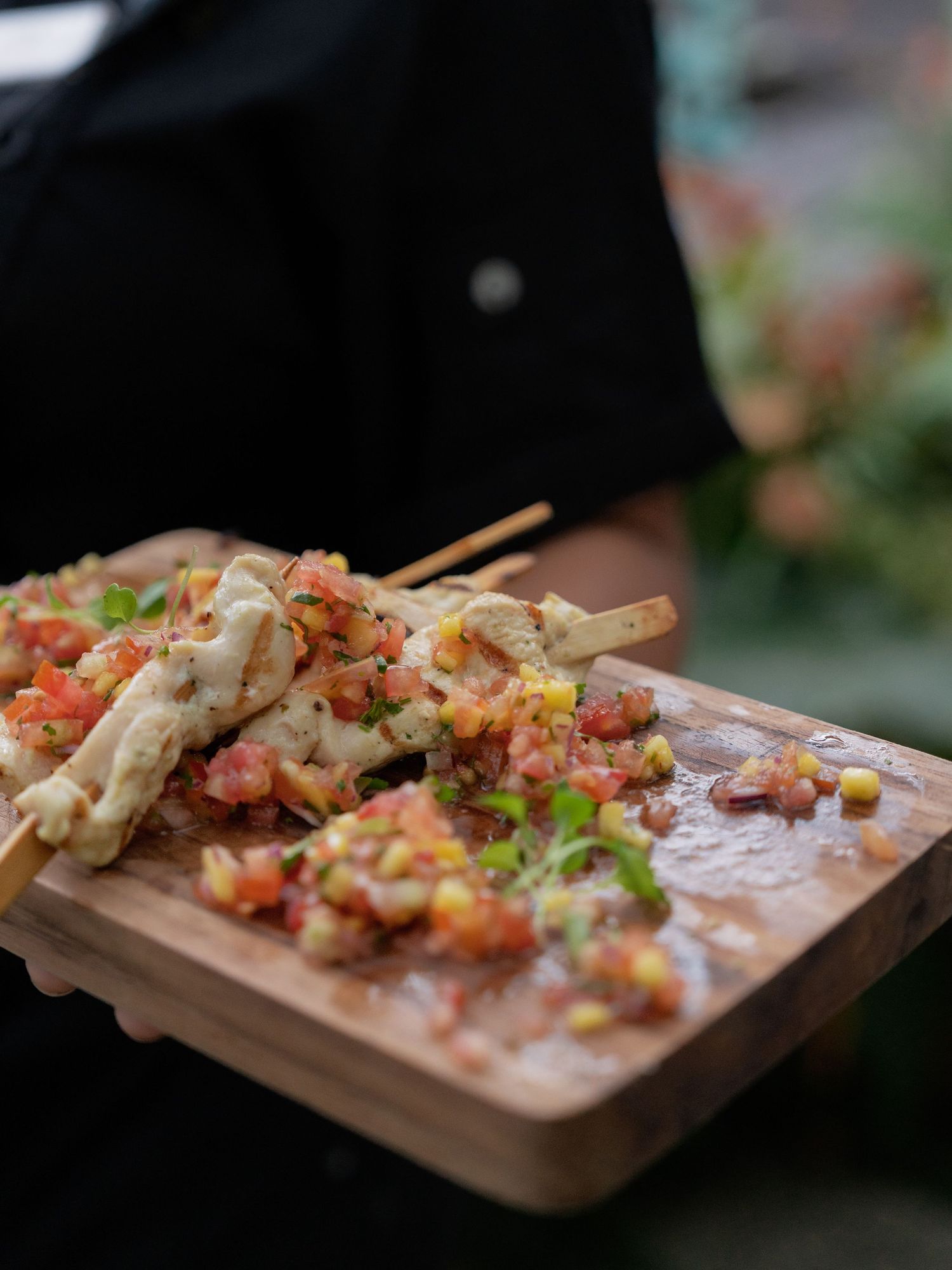 Appetizers served on wooden boards with colorful toppings and garnishes.