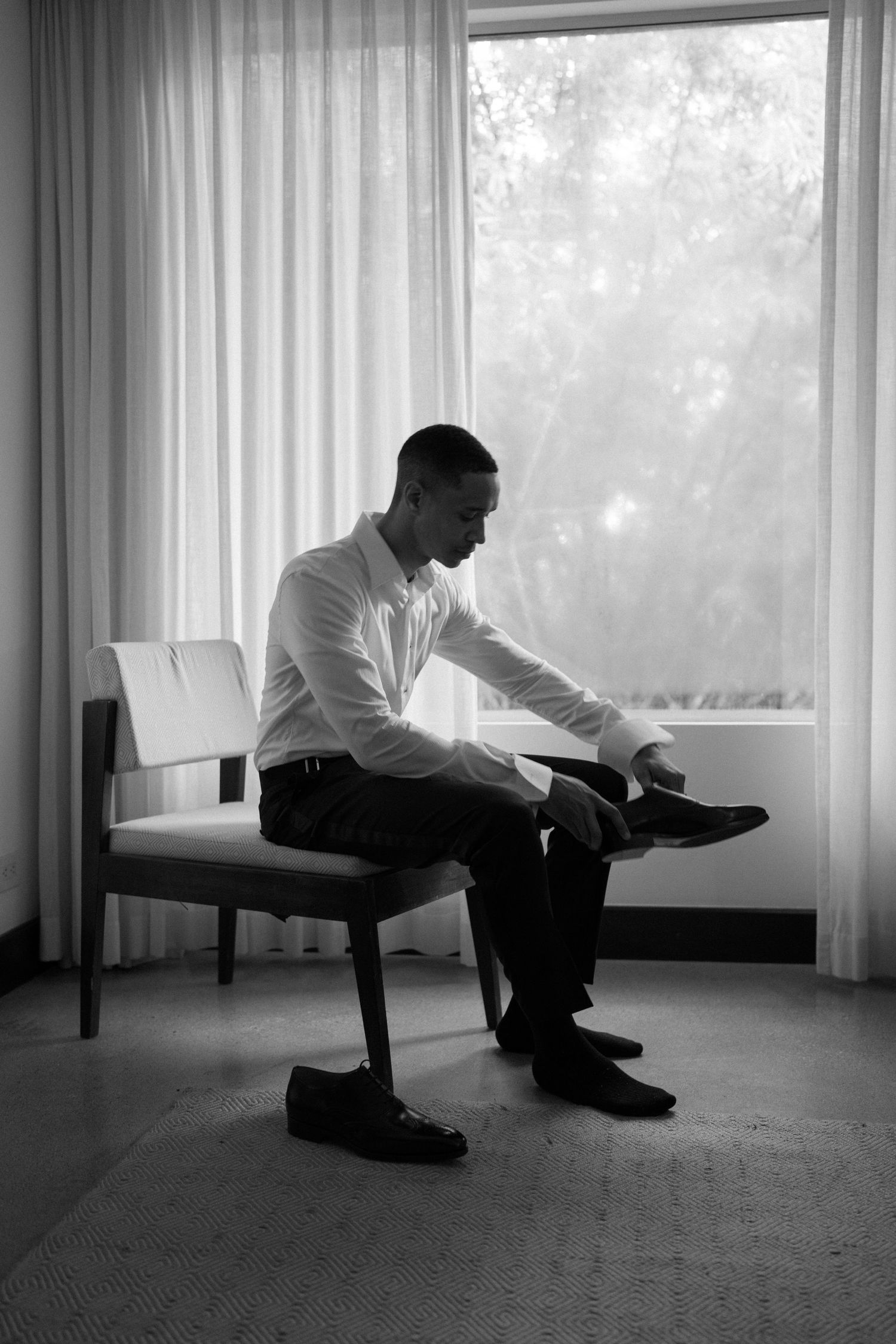 Black and white photo sequence showing a person sitting alone by a window in contemplative poses.
