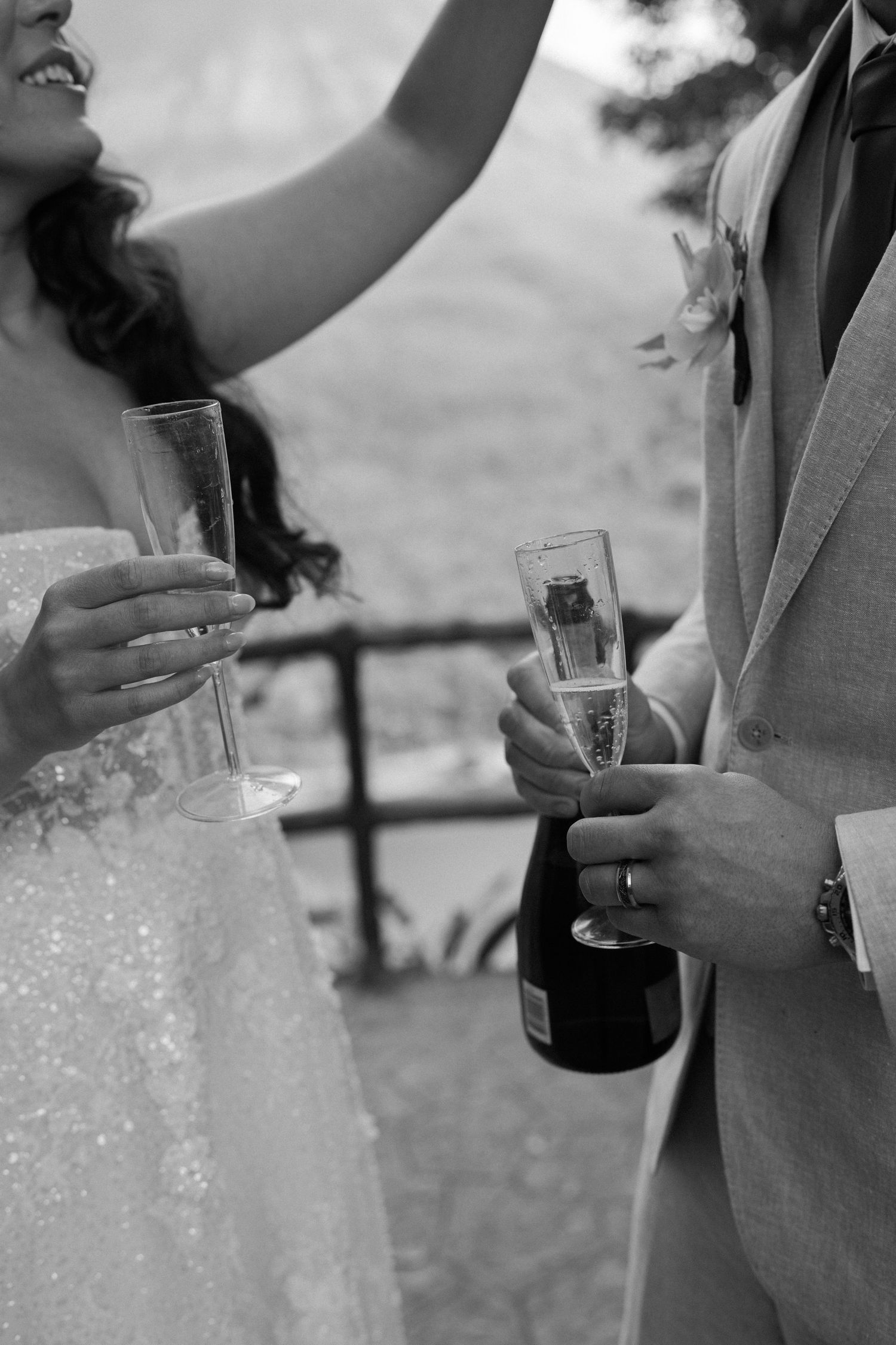 Close-up shots of wedding couple holding drinks during outdoor celebration.