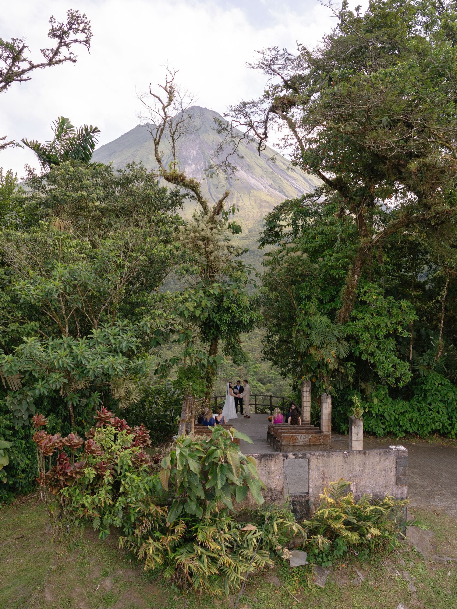 A scenic mountain landscape with lush greenery and rustic structures.