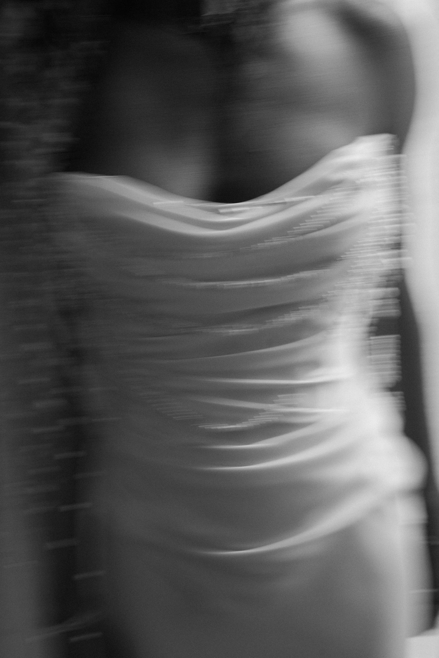Abstract black and white close-up of flowing fabric creating elegant wave patterns.