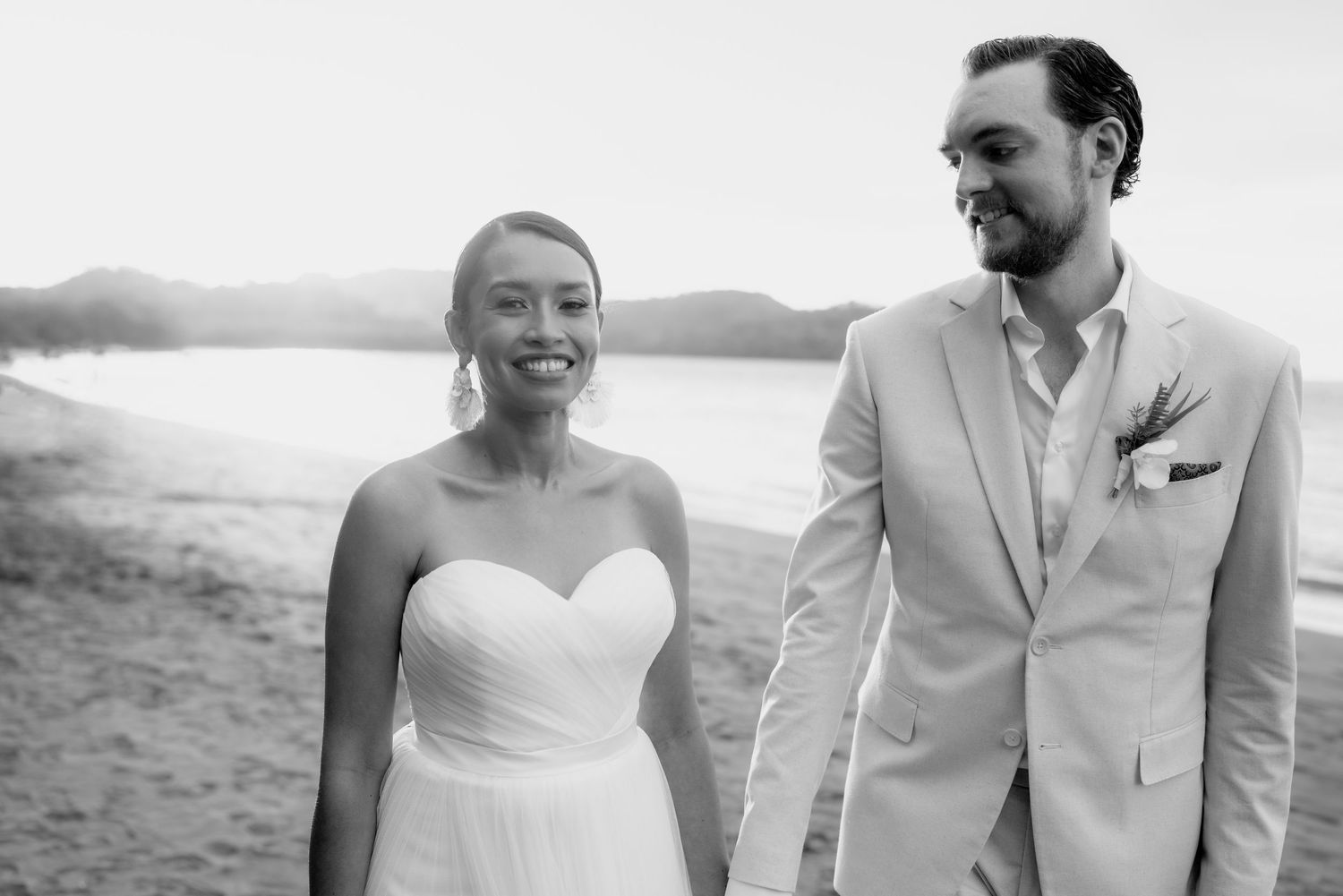 A collection of intimate beach wedding portraits showing a couple in white formal attire.