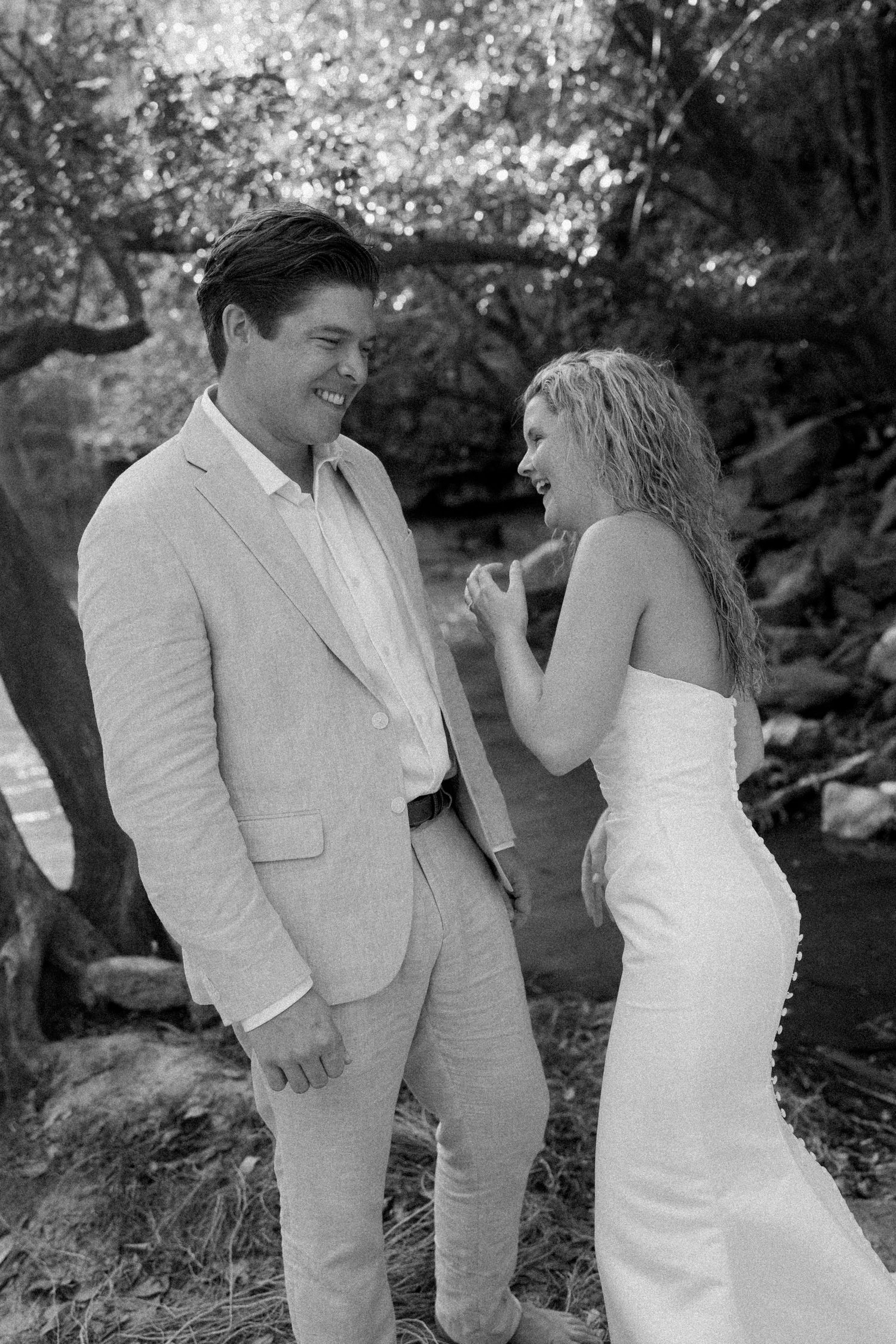 Black and white wedding photos showing a couple in formal attire sharing intimate moments outdoors.