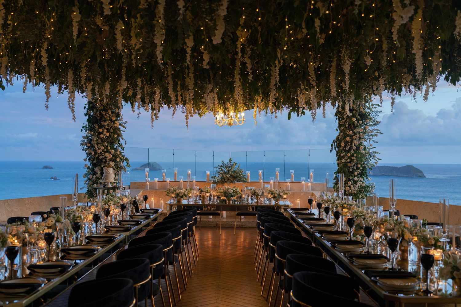 Stunning overhead wedding reception decor with hanging floral arrangements and ambient lighting.