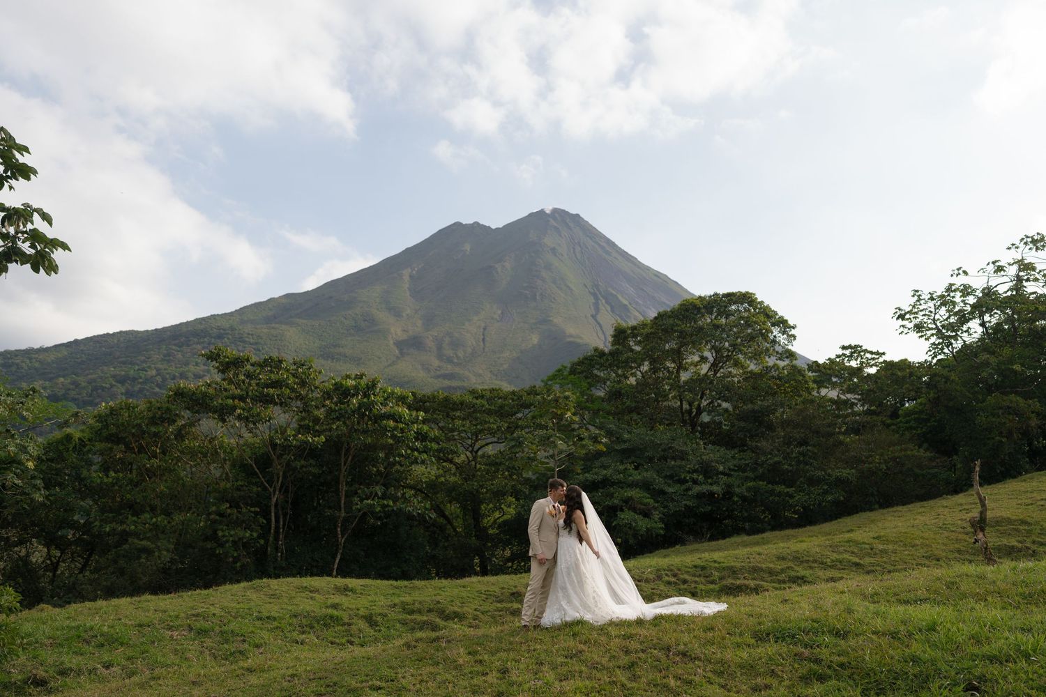 Panoramic mountain landscape with wedding photography session in progress.