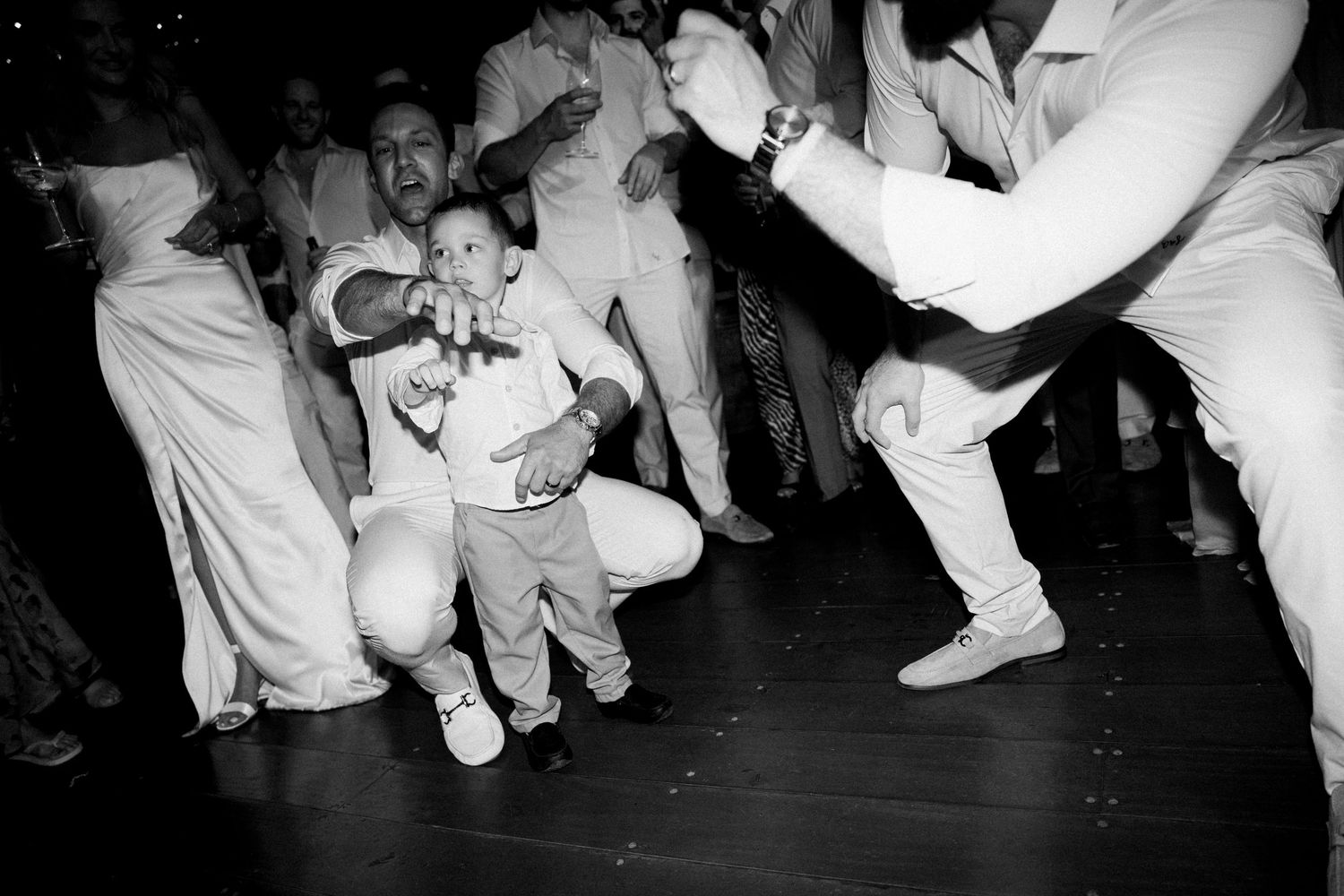 Black and white photos showing low angle views of dancing feet at a celebration.