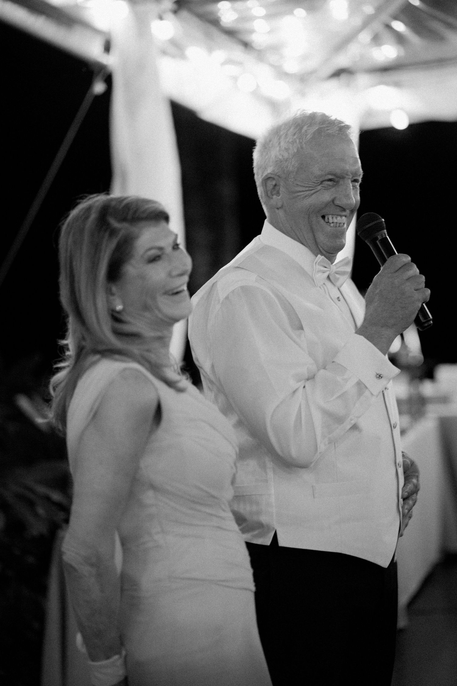Black and white photos show a couple dancing and laughing together at a wedding reception.