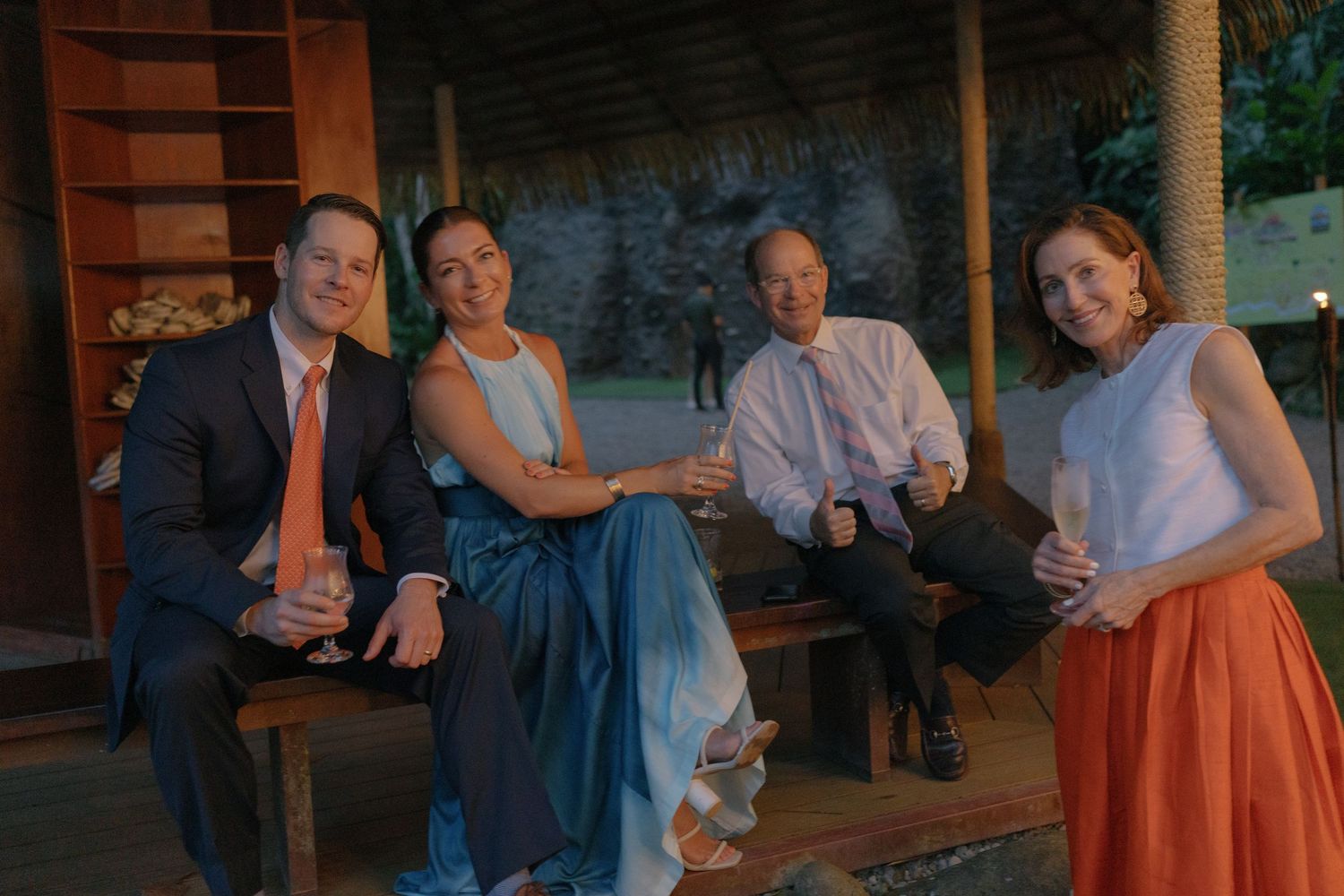 Wedding reception guests enjoying casual conversations at outdoor tables.