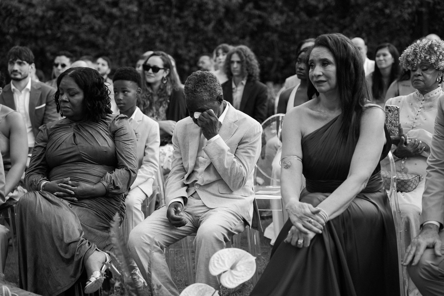 Wedding guests enjoying outdoor celebration in casual summer attire.