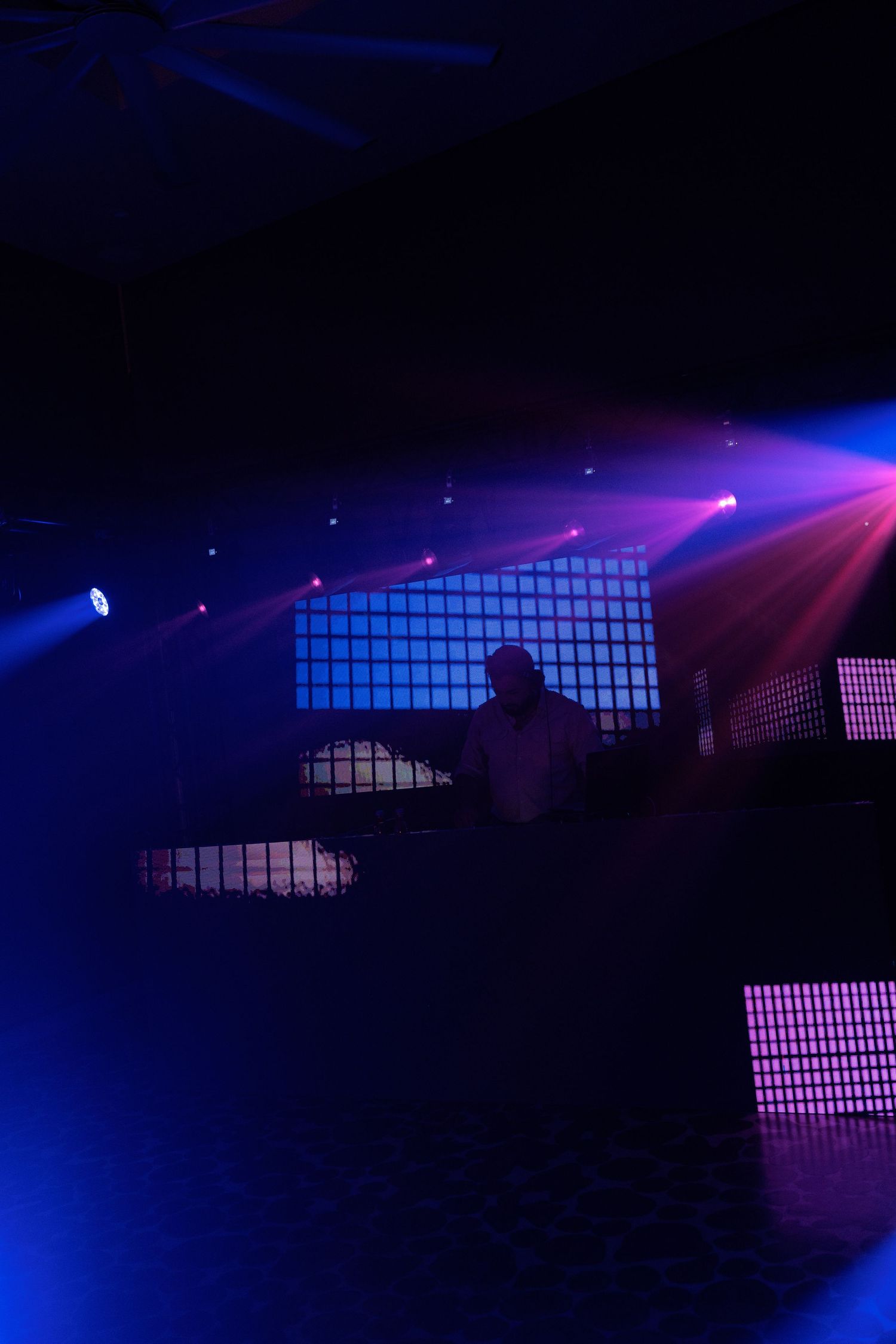 Concert venue with dramatic blue and purple lighting effects.
