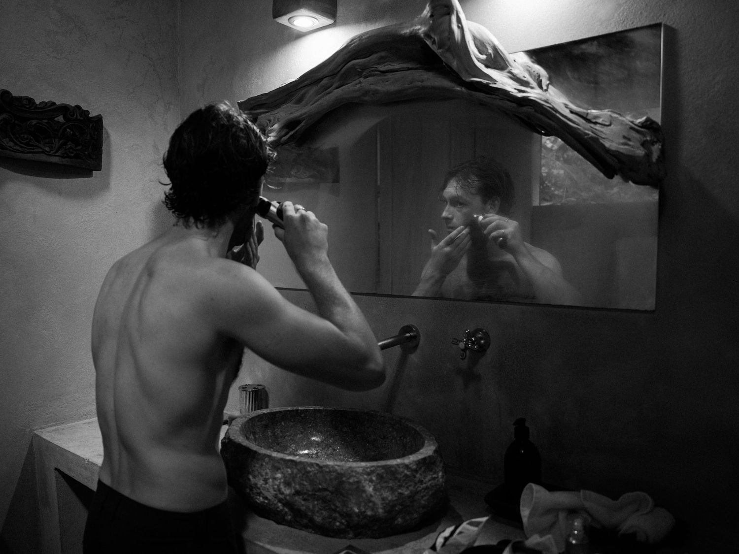 Moody black and white photography sequence in a dimly lit interior.
