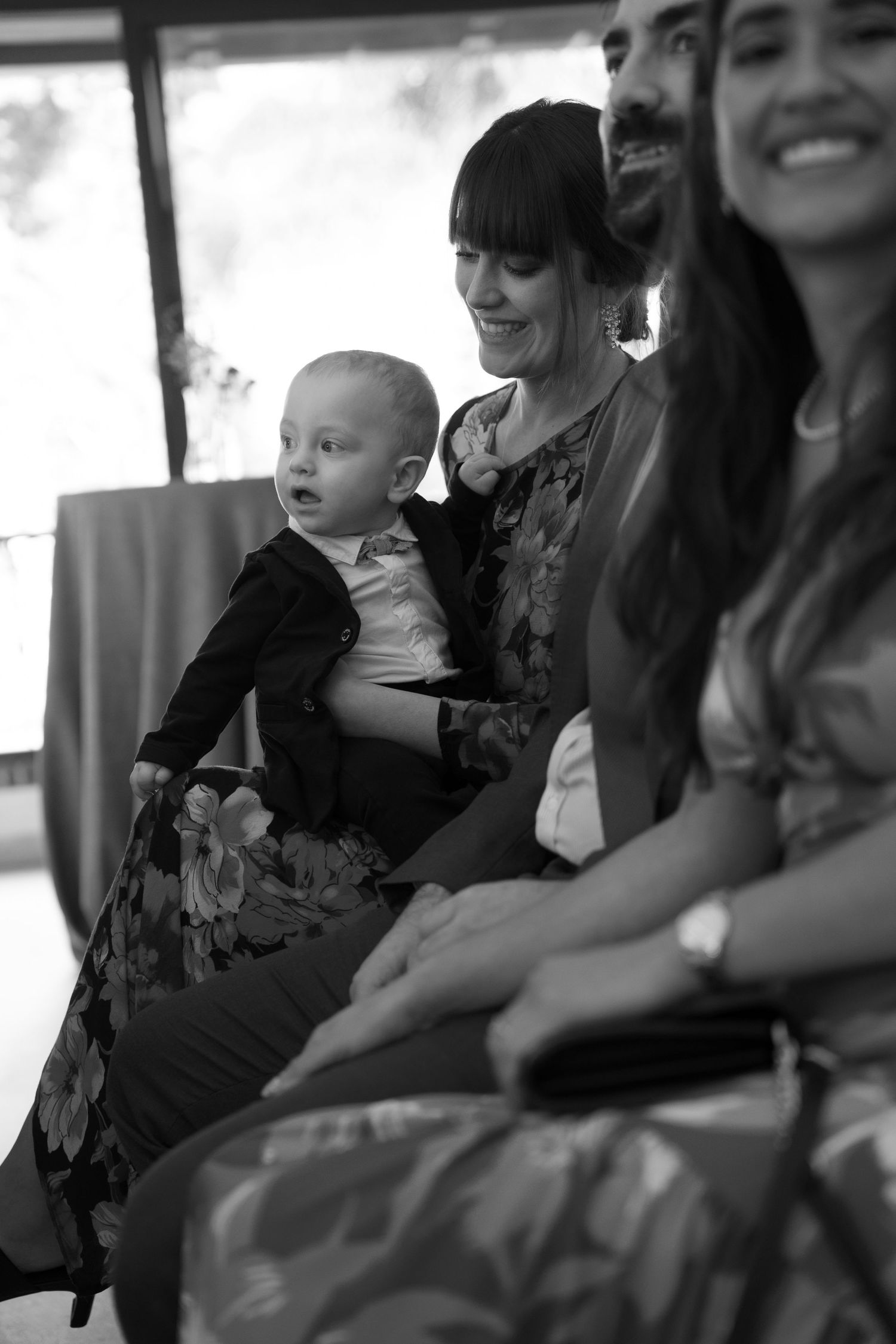 A black and white photo showing wedding guests sitting together