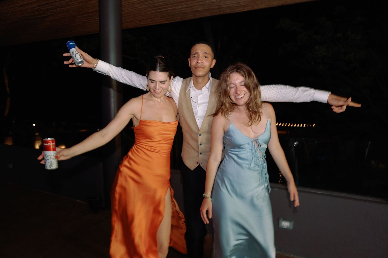 Party guests dancing and celebrating at a nighttime event.