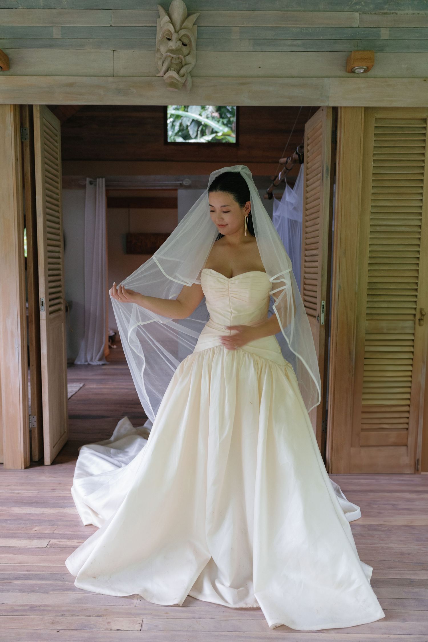 Elegant bridal portraits showing the movement and details of a classic white wedding gown.