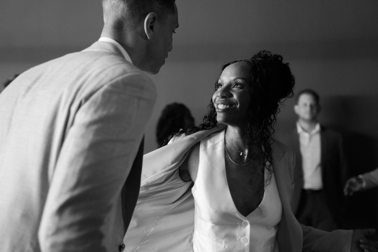 Black and white candid moments captured during a wedding celebration.