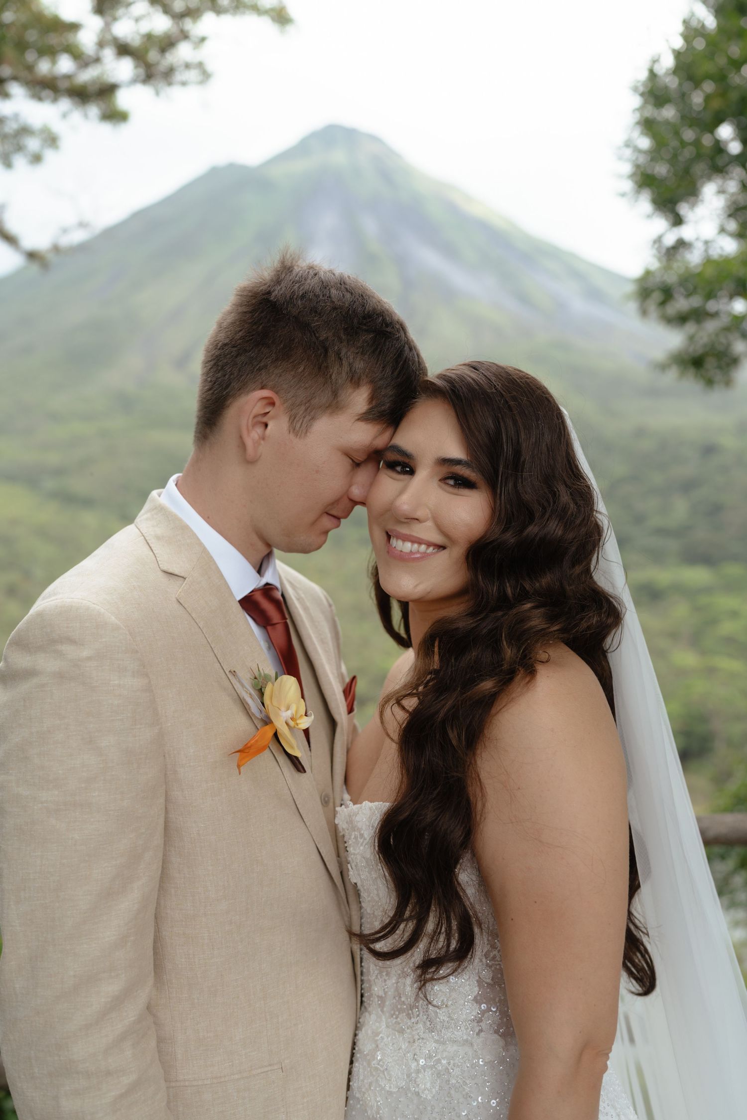 Intimate wedding portraits with mountain backdrop and natural lighting.