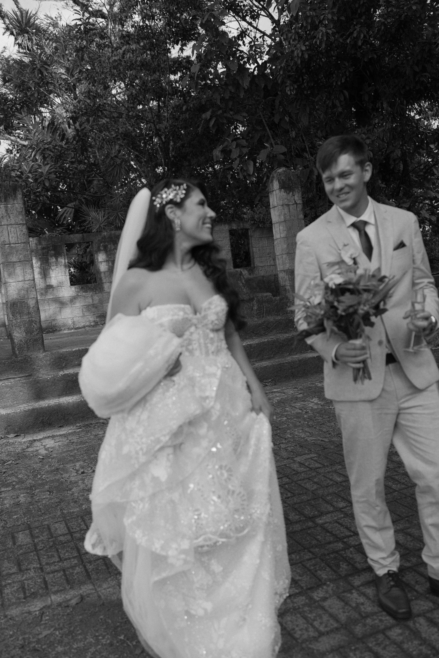 Black and white wedding photos showing a couple dancing outdoors.
