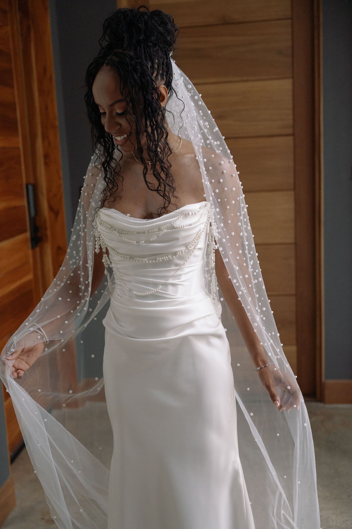 Elegant white wedding dress with sparkly veil shown from multiple angles in a bridal fitting.