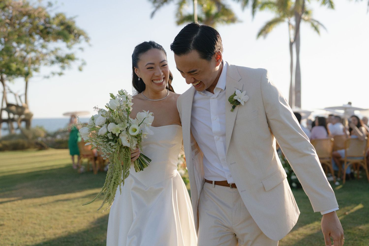 Newlyweds share intimate moments during sunset photos at their beach wedding.