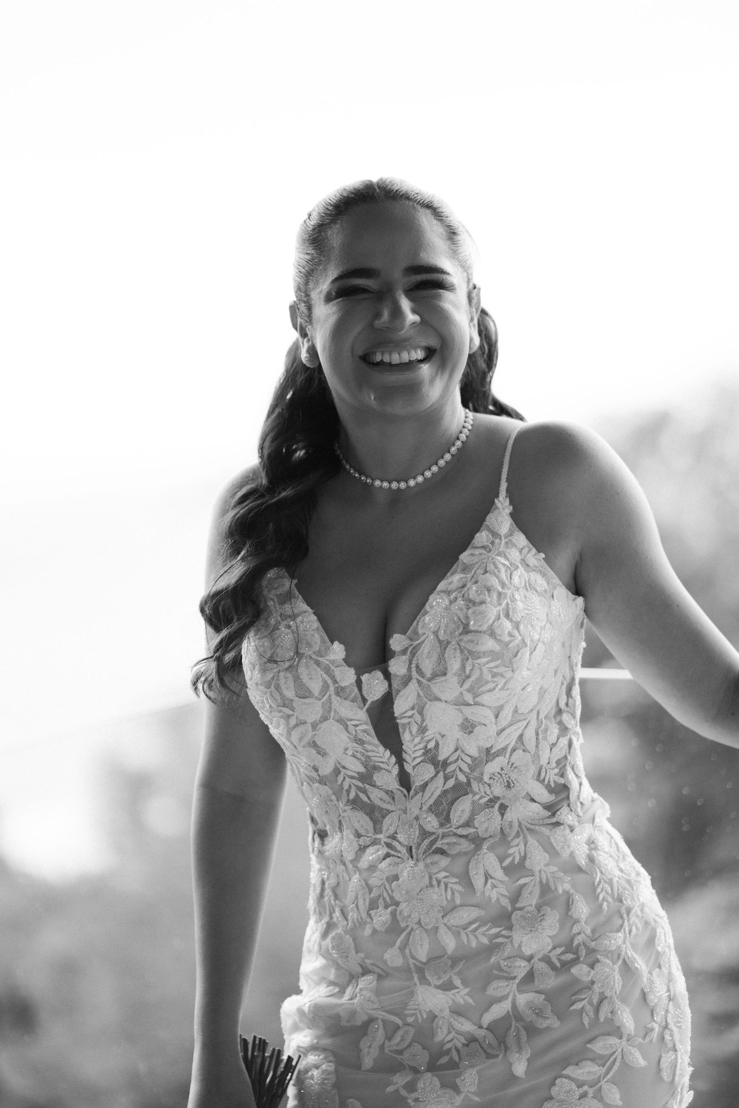 Close up of a beautiful lace wedding dress with intricate floral details.
