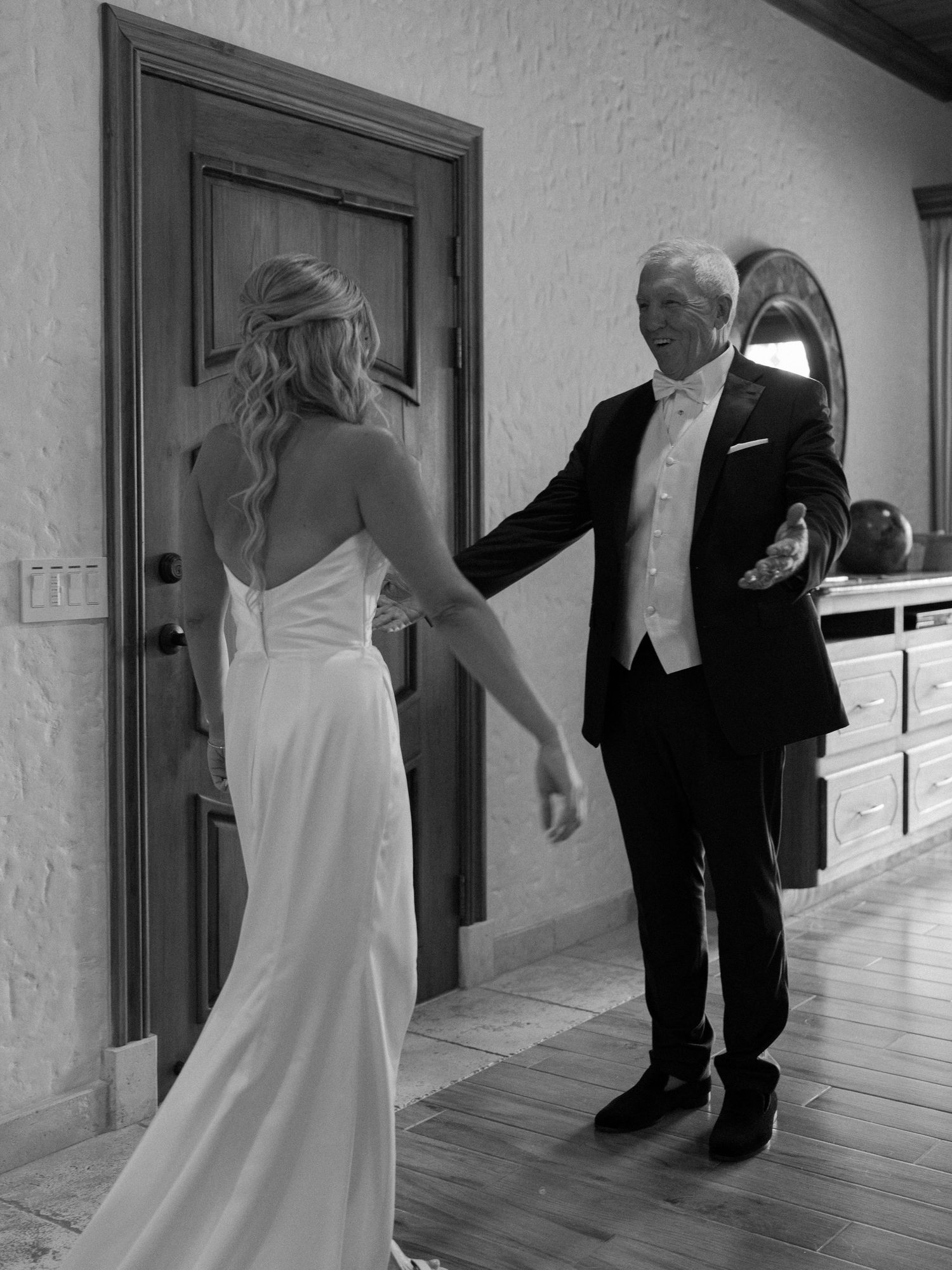 Black and white photo of a tender moment during a wedding celebration.