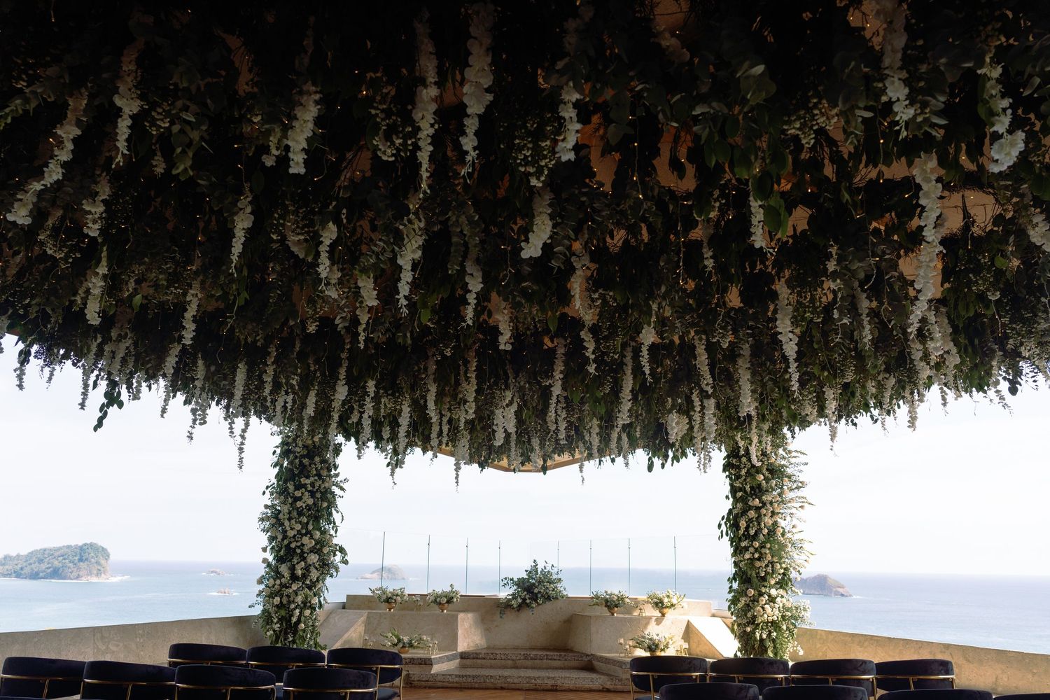 Rustic wooden beams covered in dried flowers and foliage create a natural ceiling decoration.
