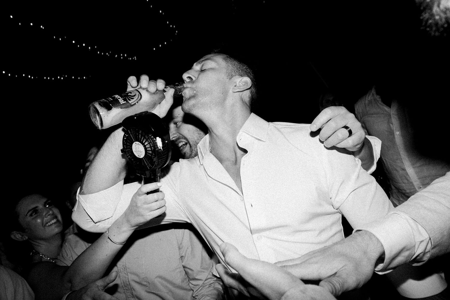 Black and white sequence captures joyful dance moves at a wedding celebration.