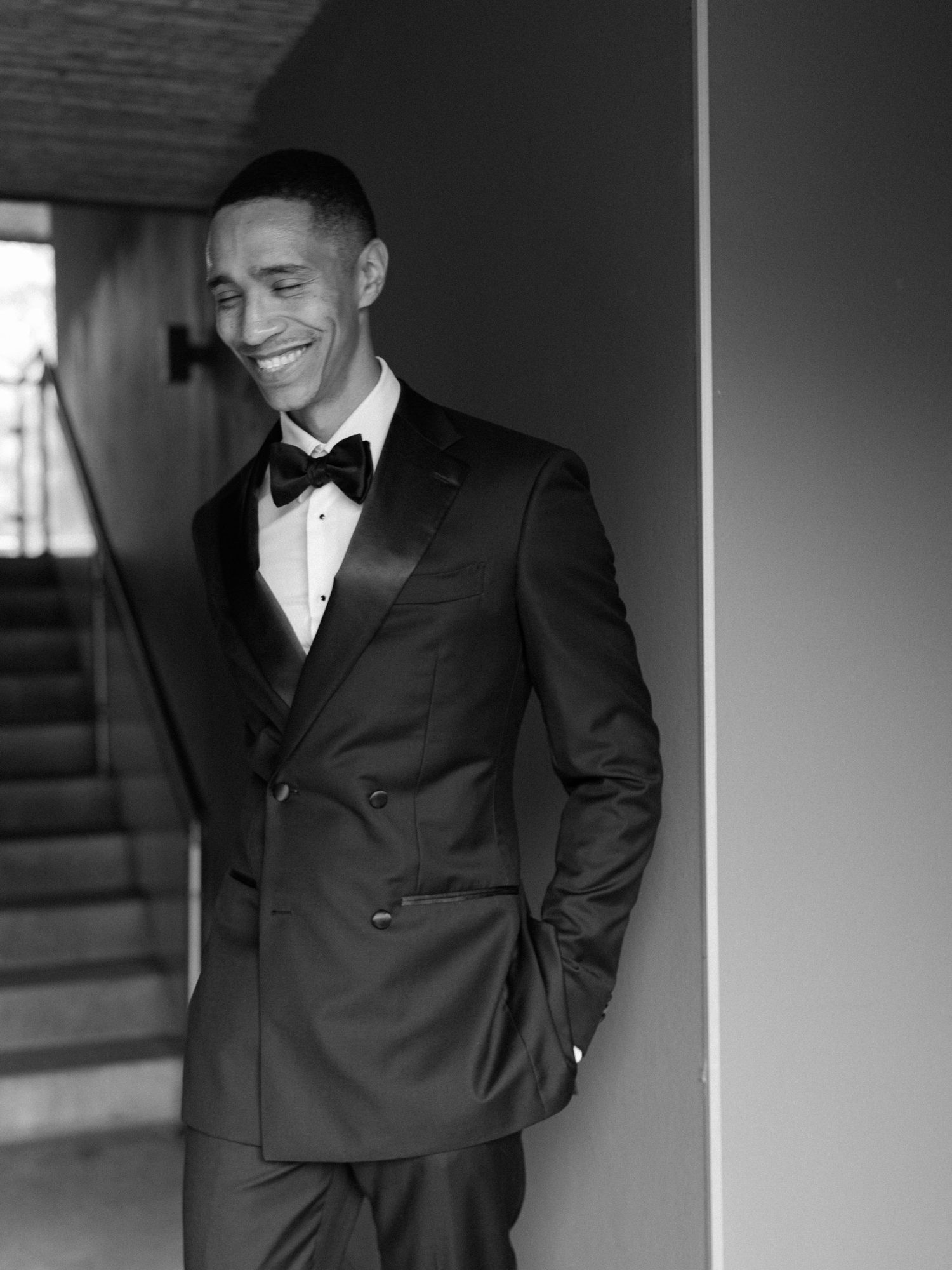 Formal black and white portrait session in an elegant indoor setting.