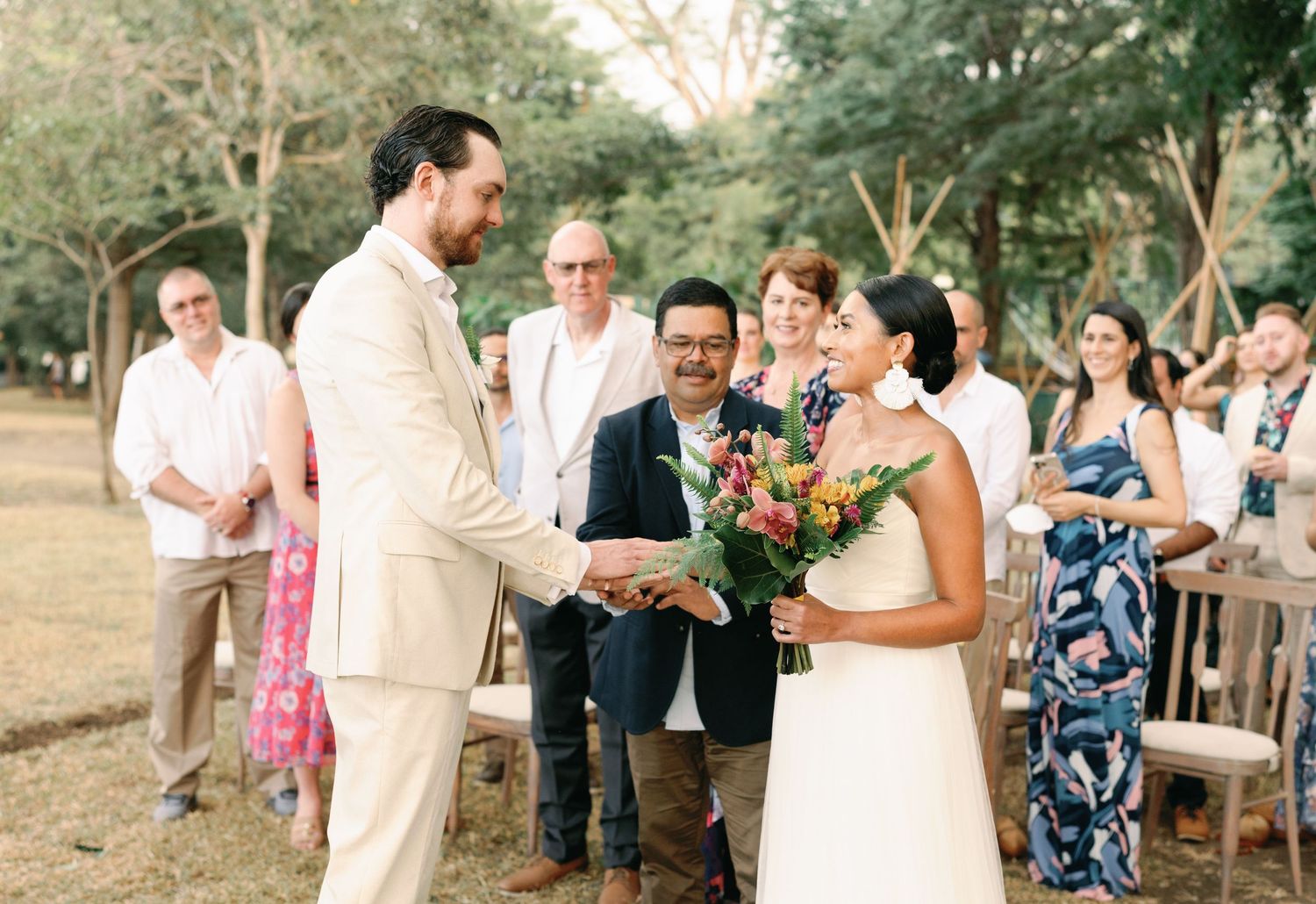 Wedding guests gathered at outdoor reception celebrating with the newlyweds.