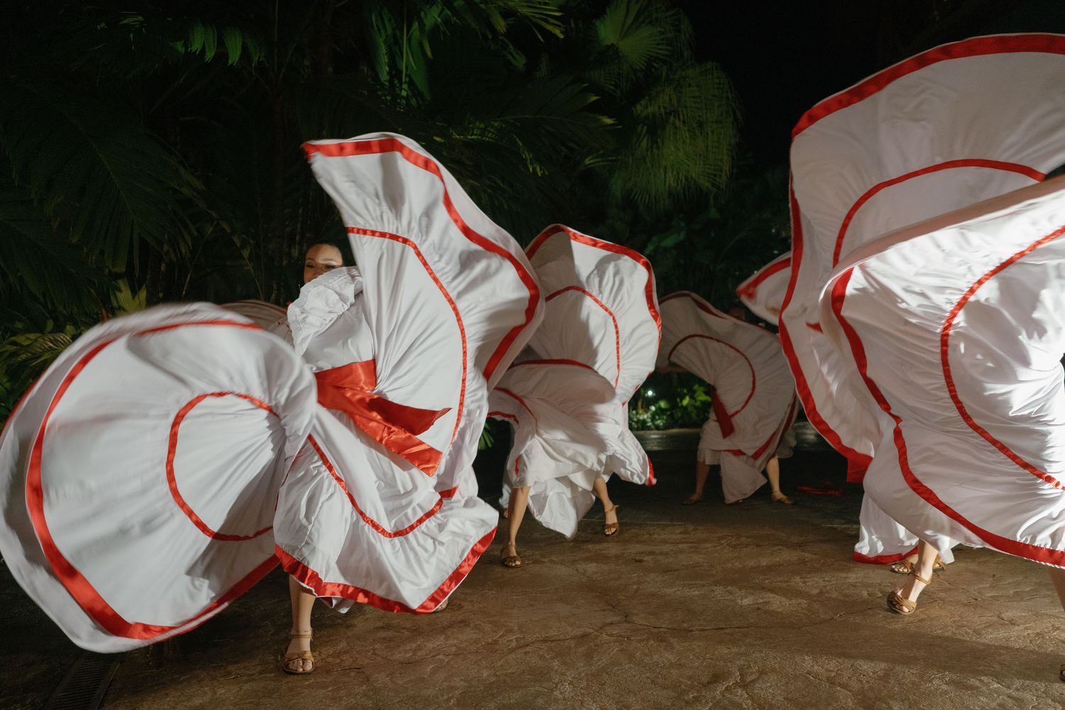 Series of photos showing swirling white dresses in motion against dark background.