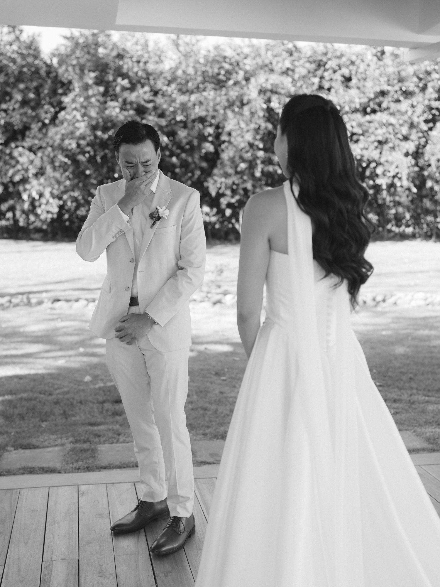 Series of intimate black and white wedding photos showing couple's first look moments on a wooden deck.