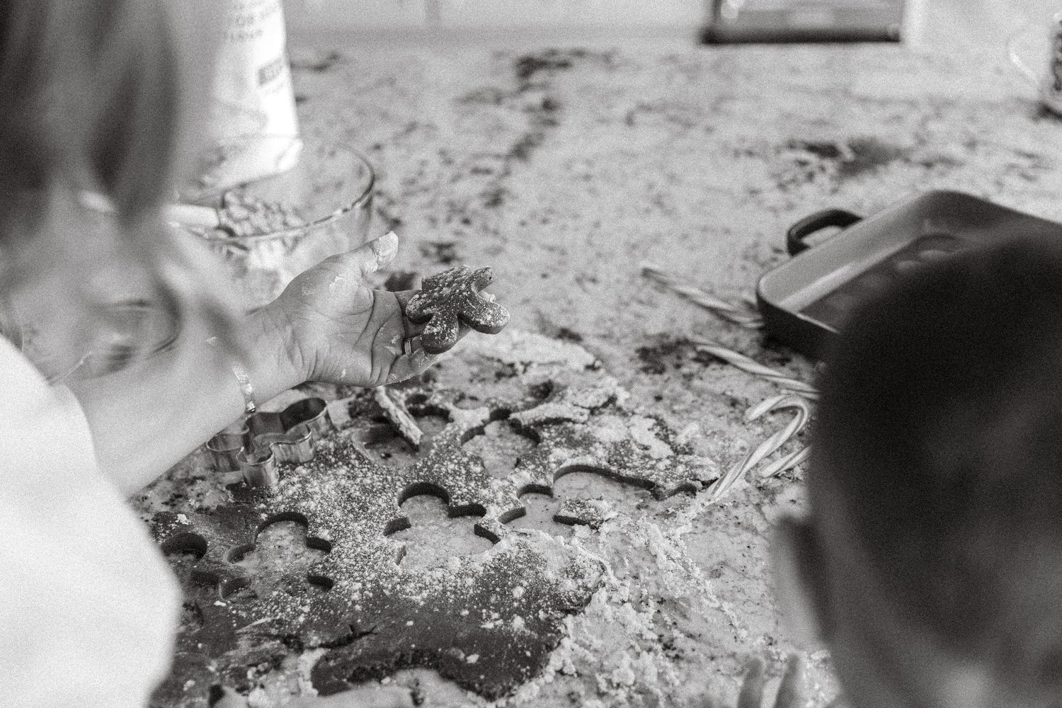 Children playing in sand, examining crabs in black and white photo.