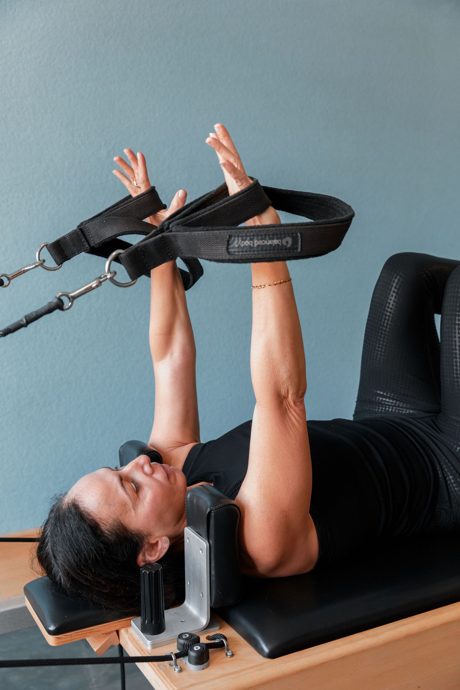 Person demonstrating proper form on weight bench during chest press exercise.