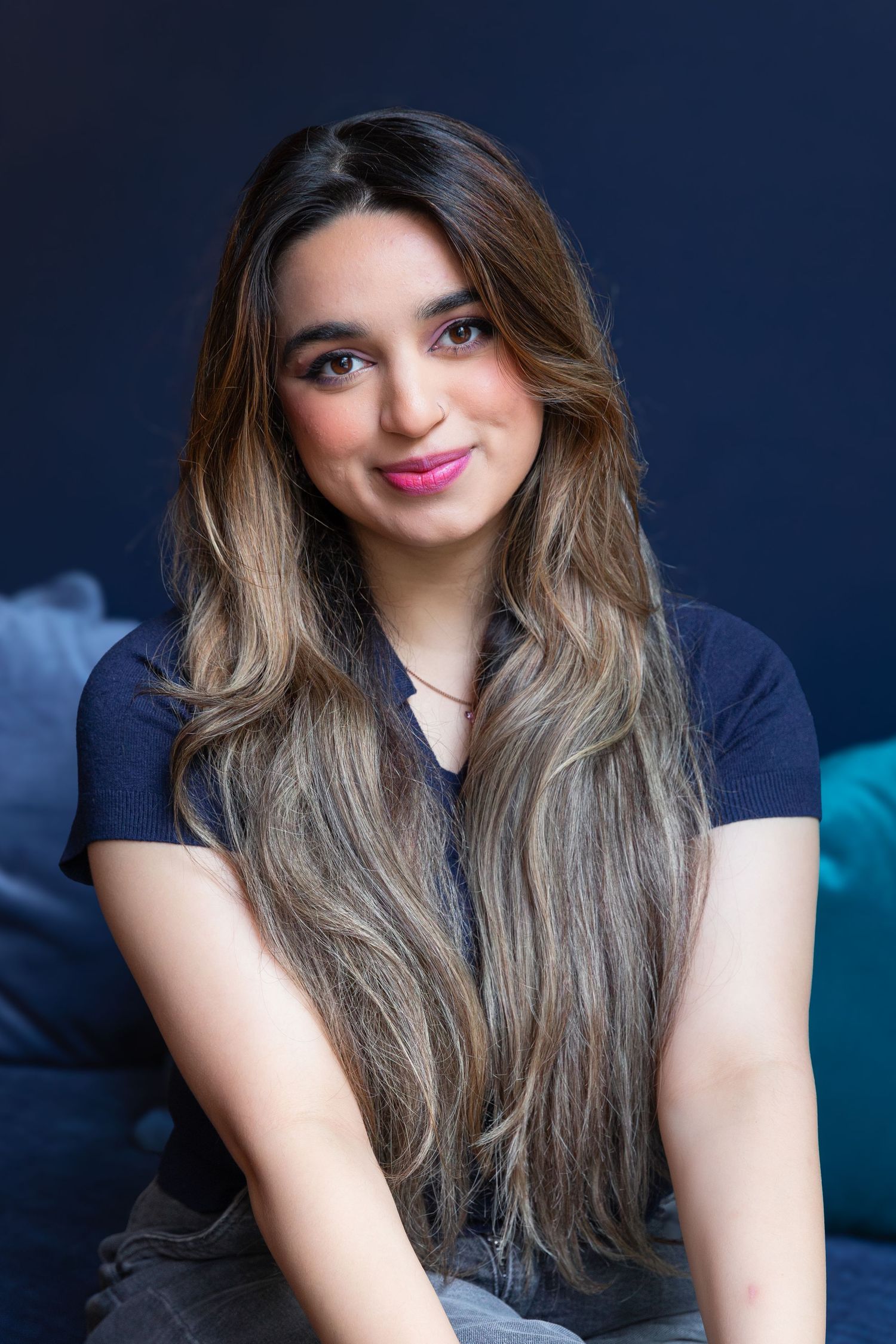Portrait series against navy background showing casual relaxed poses.