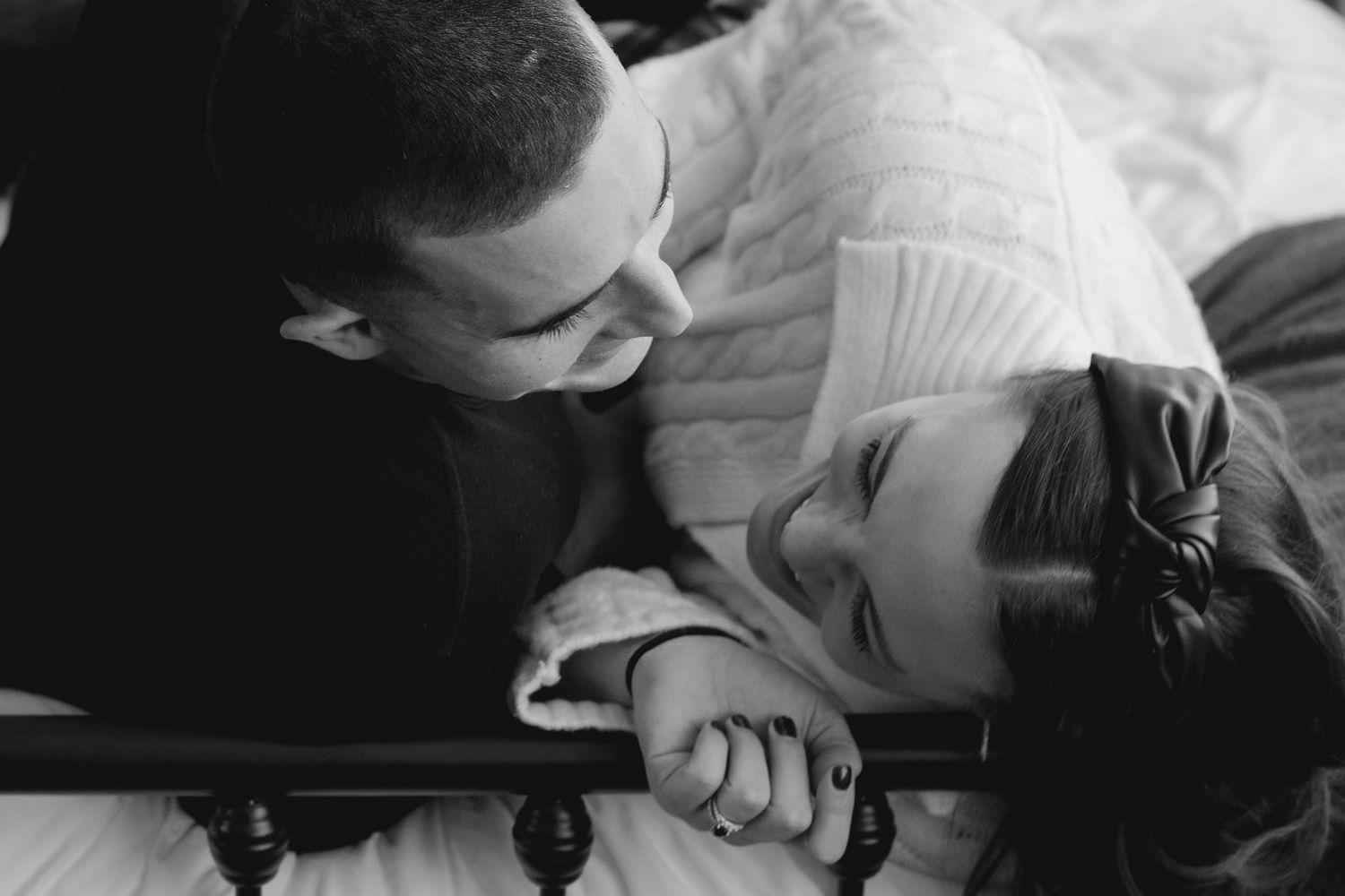 A romantic black and white photograph of a couple sharing an intimate moment together.
