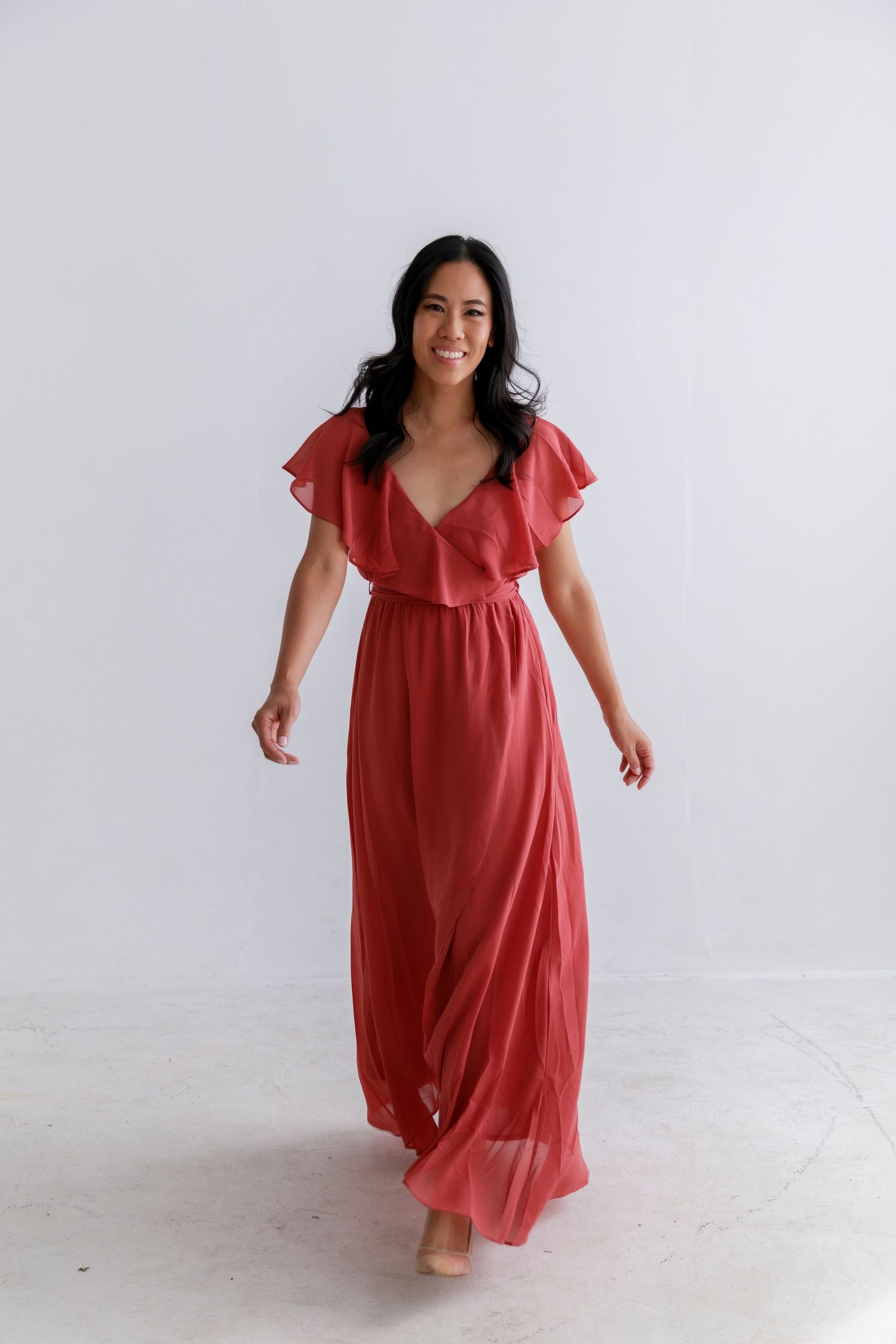 Coral red chiffon maxi dress featuring flutter sleeves and v-neckline.
