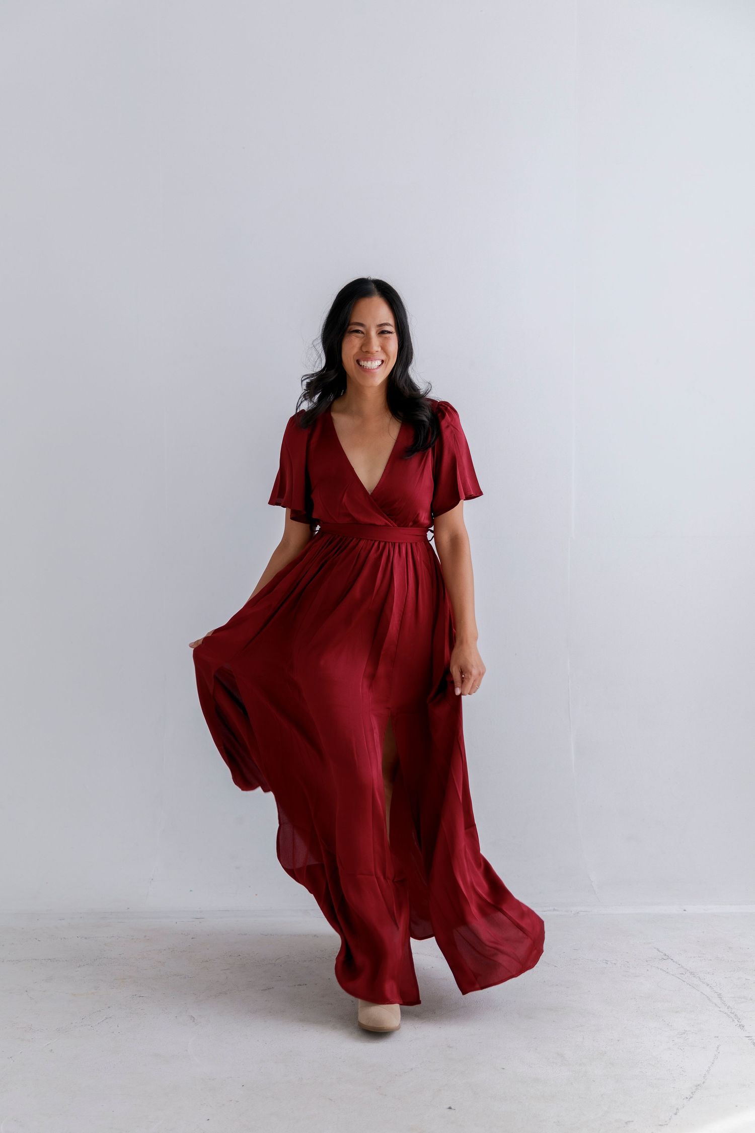 Burgundy chiffon maxi dress with flutter sleeves and wrap style bodice.