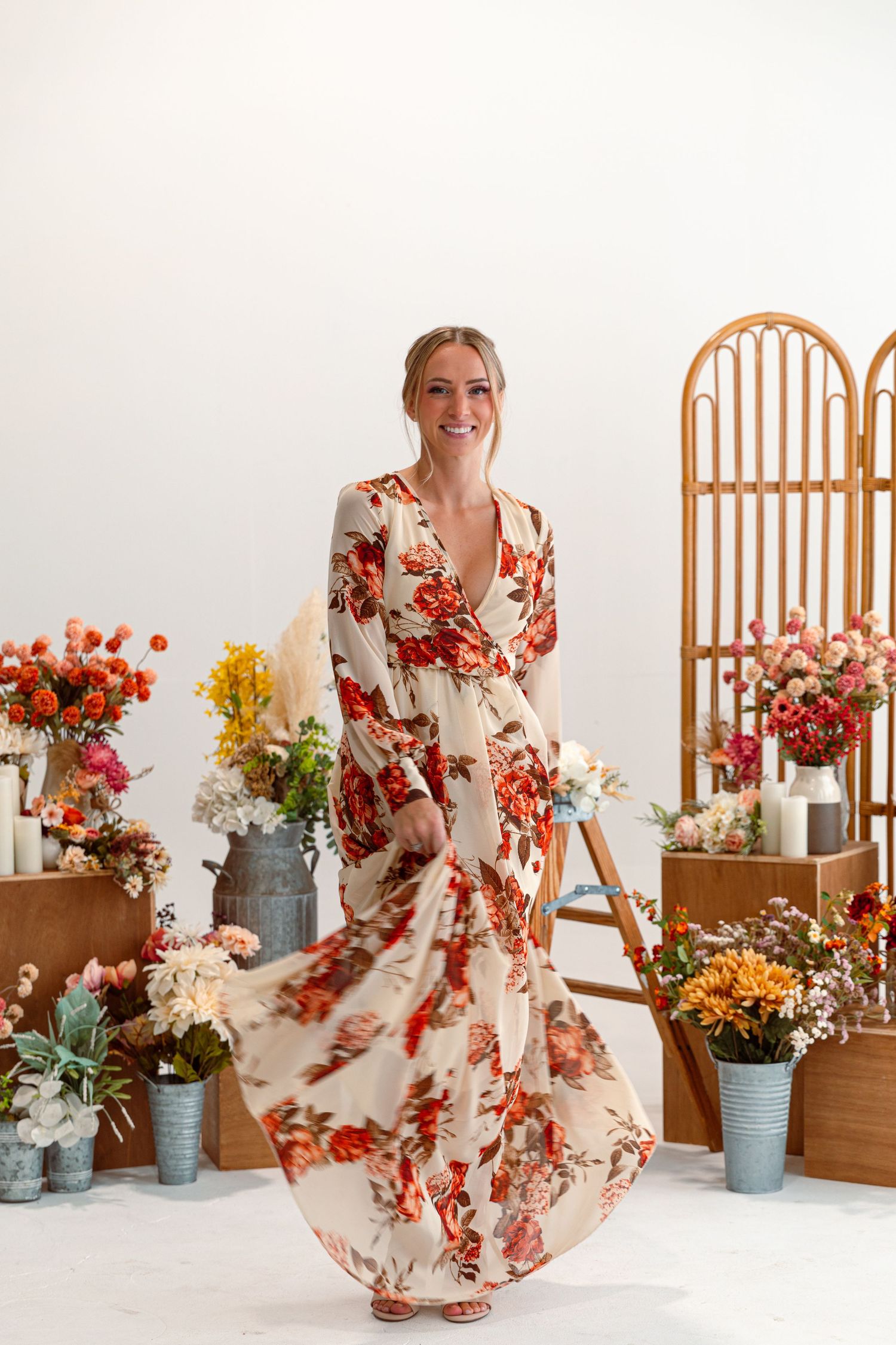 Floral print wrap maxi dress in cream and coral tones photographed with vintage rattan screen.