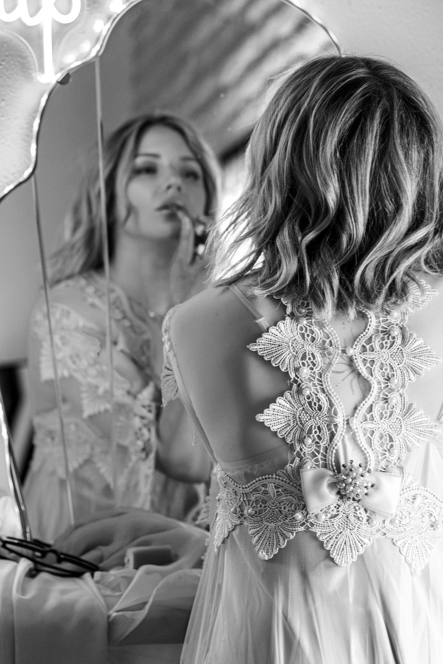 Artistic black and white portrait series featuring delicate lace details.