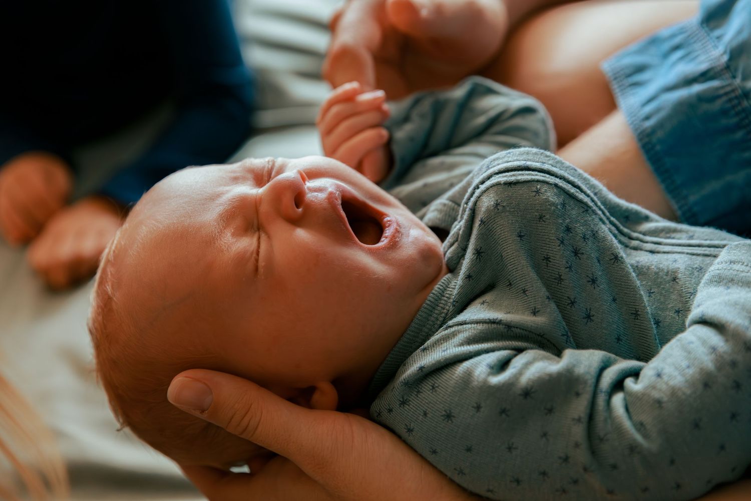 Close-up of baby making expressive faces while playing.