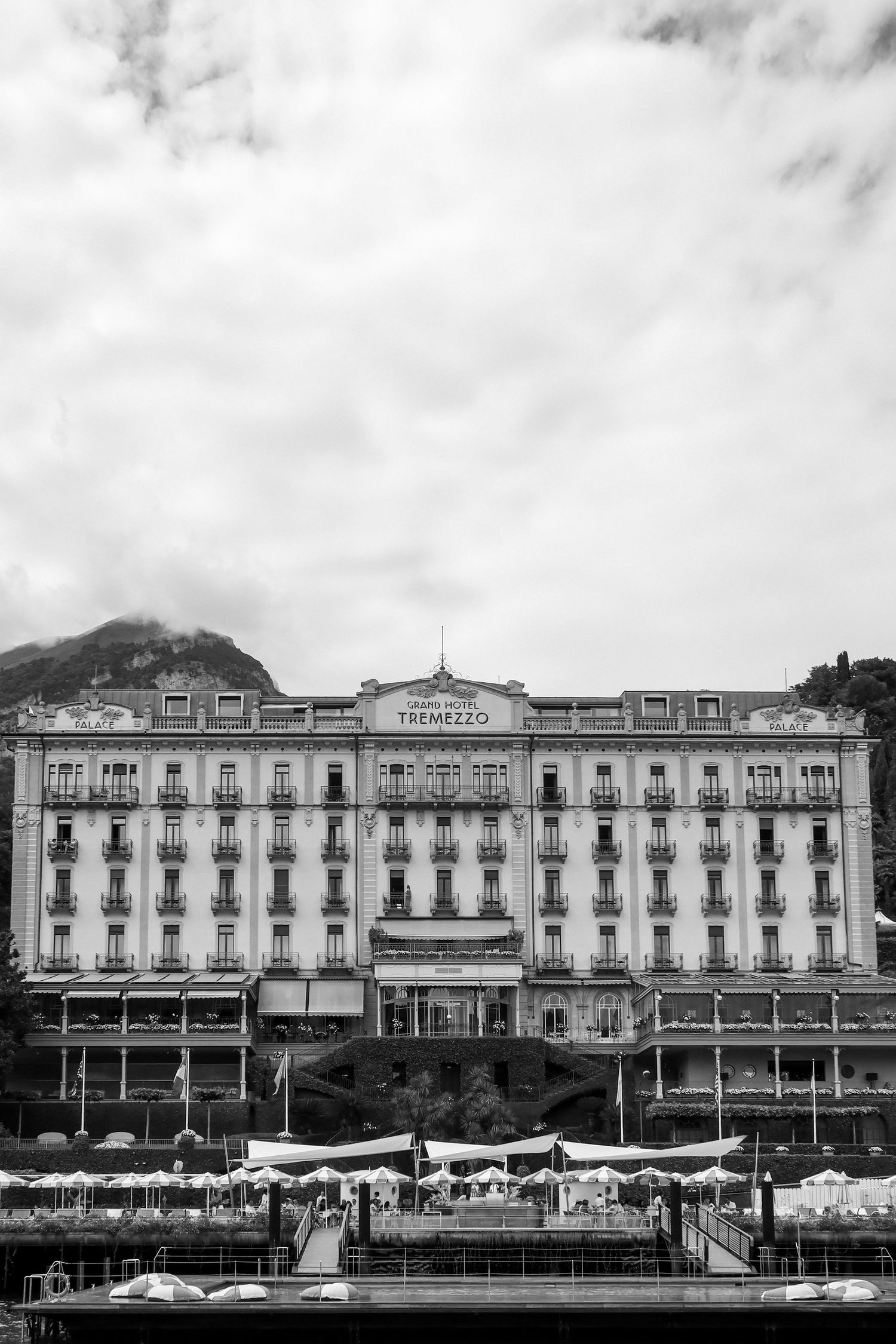 Historic Grand Hotel Tremezzo facade stretching along Lake Como waterfront in black and white.