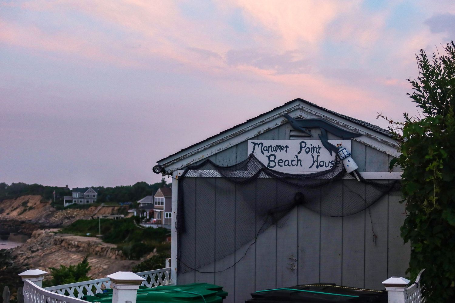 Sunset view of buildings with pink and purple sky in the background.