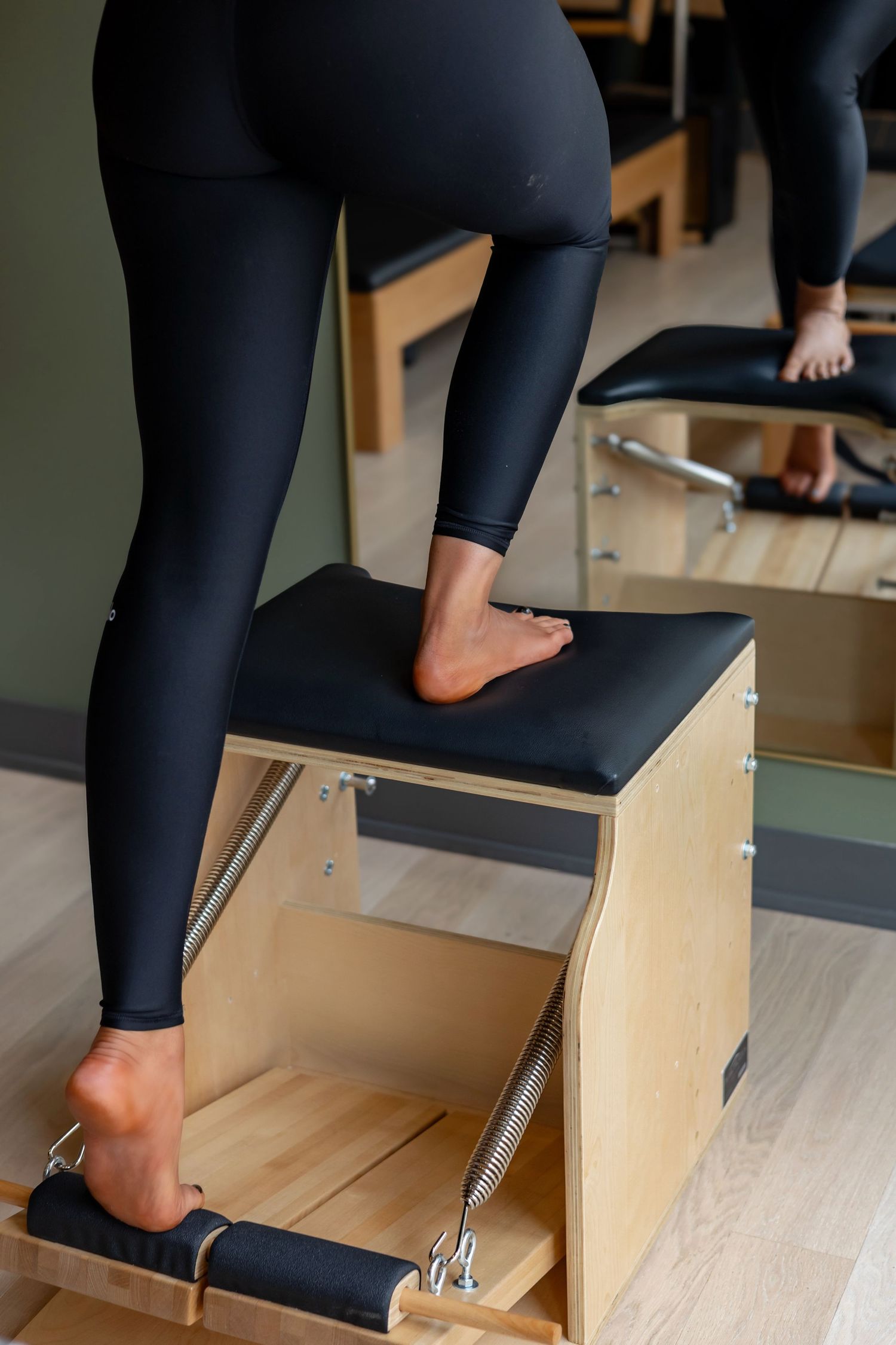 Step-by-step demonstration of footwork exercises on a Pilates chair apparatus.
